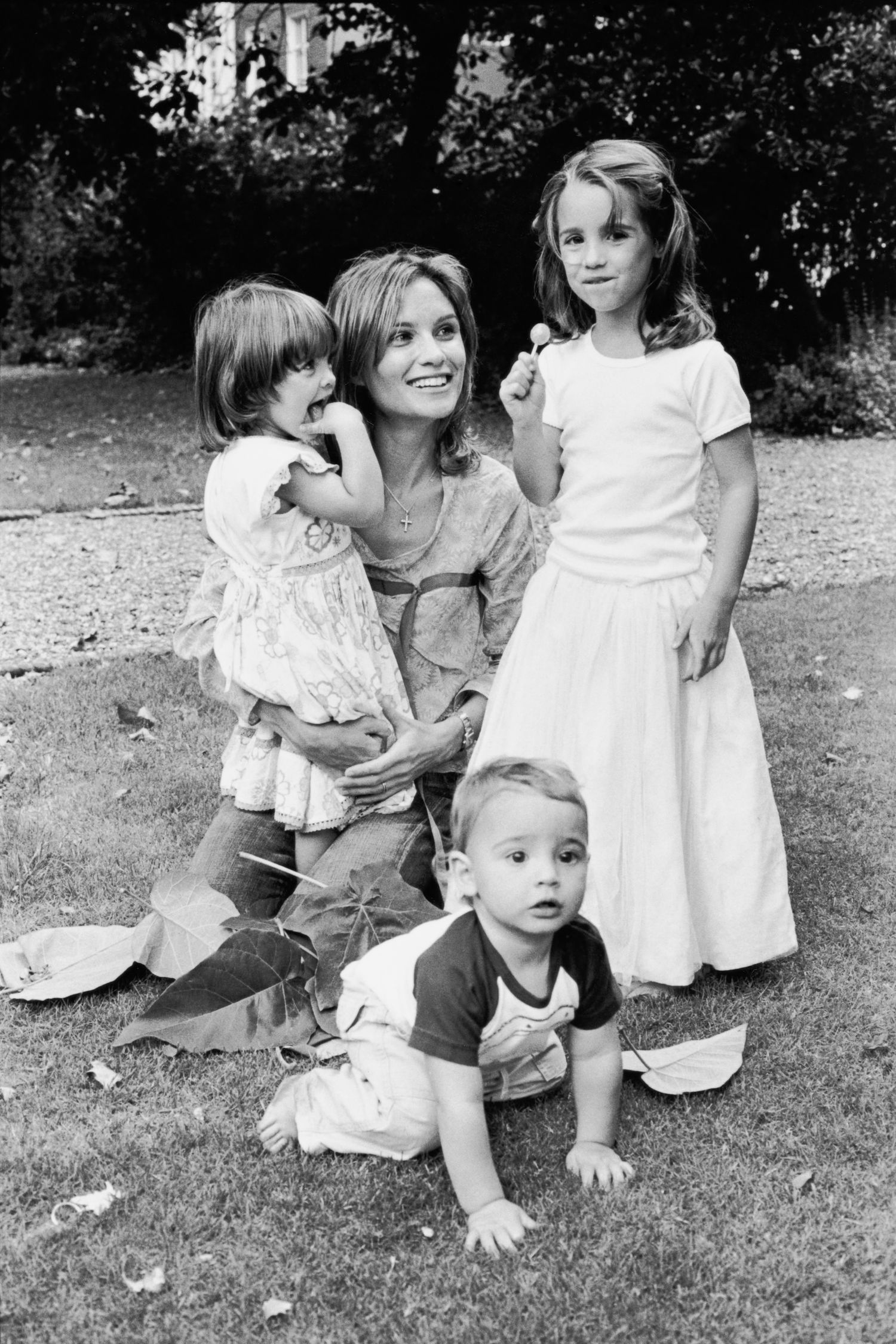 Black and white outdoor family portrait series with children in white dresses.