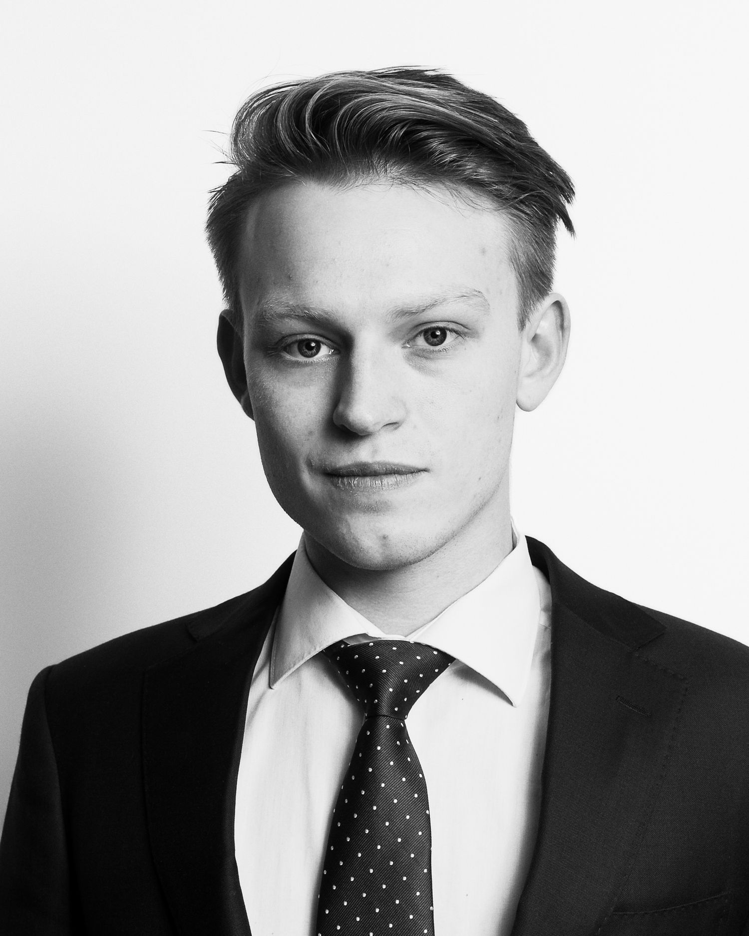 Professional headshot series of a young person in formal attire with polka dot tie against white background.