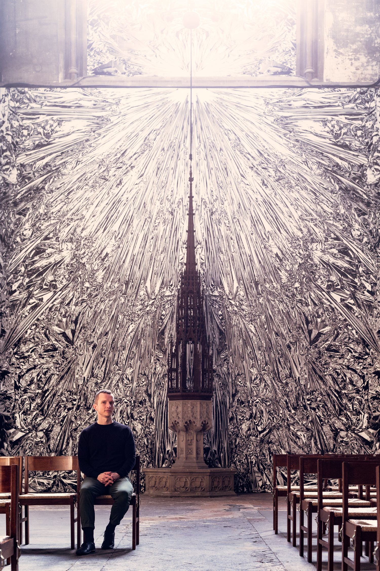 Art installation featuring a large architectural drawing with radiating lines in a gallery space.