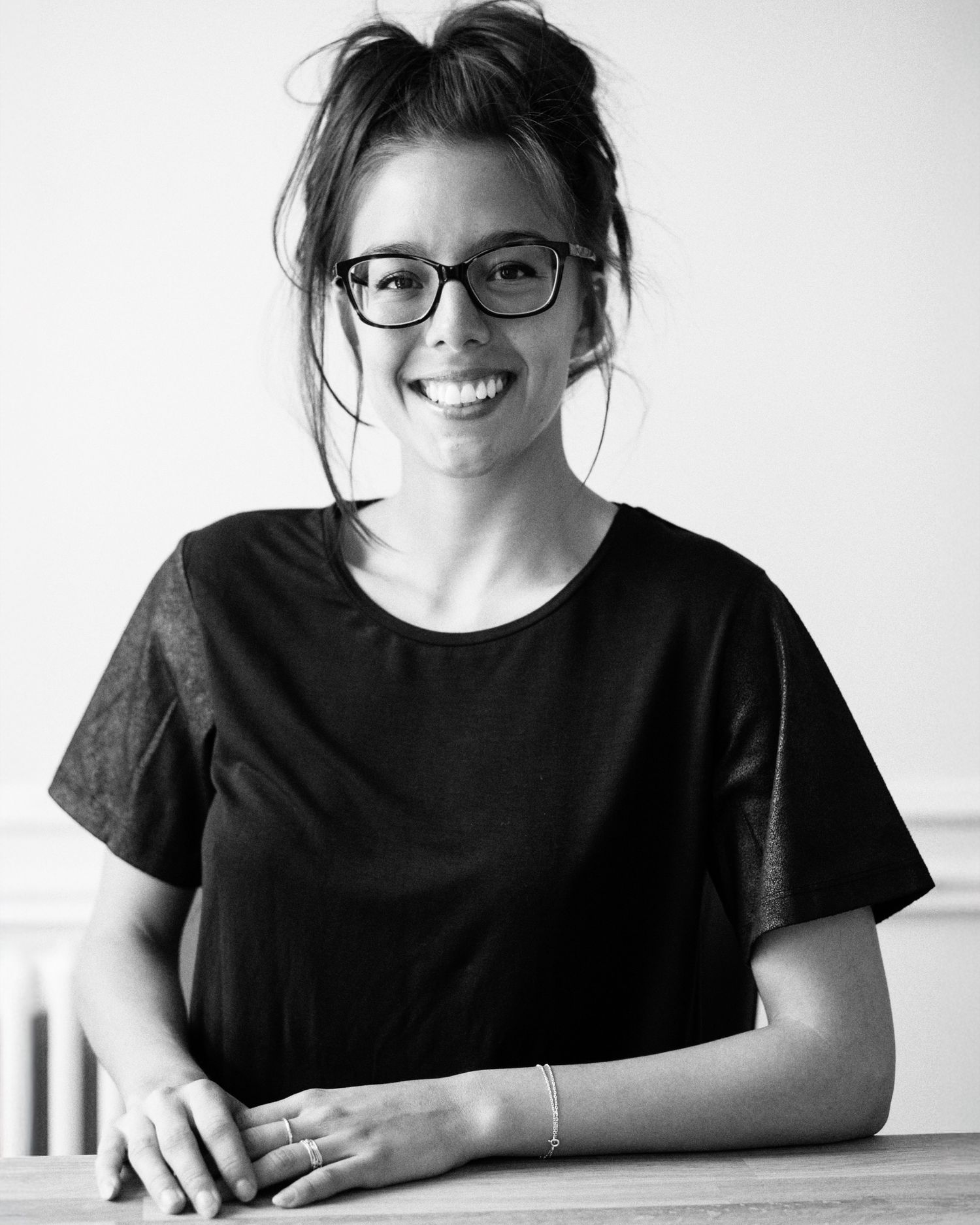 Business headshot Black and white portrait series showing someone in casual attire with glasses.
