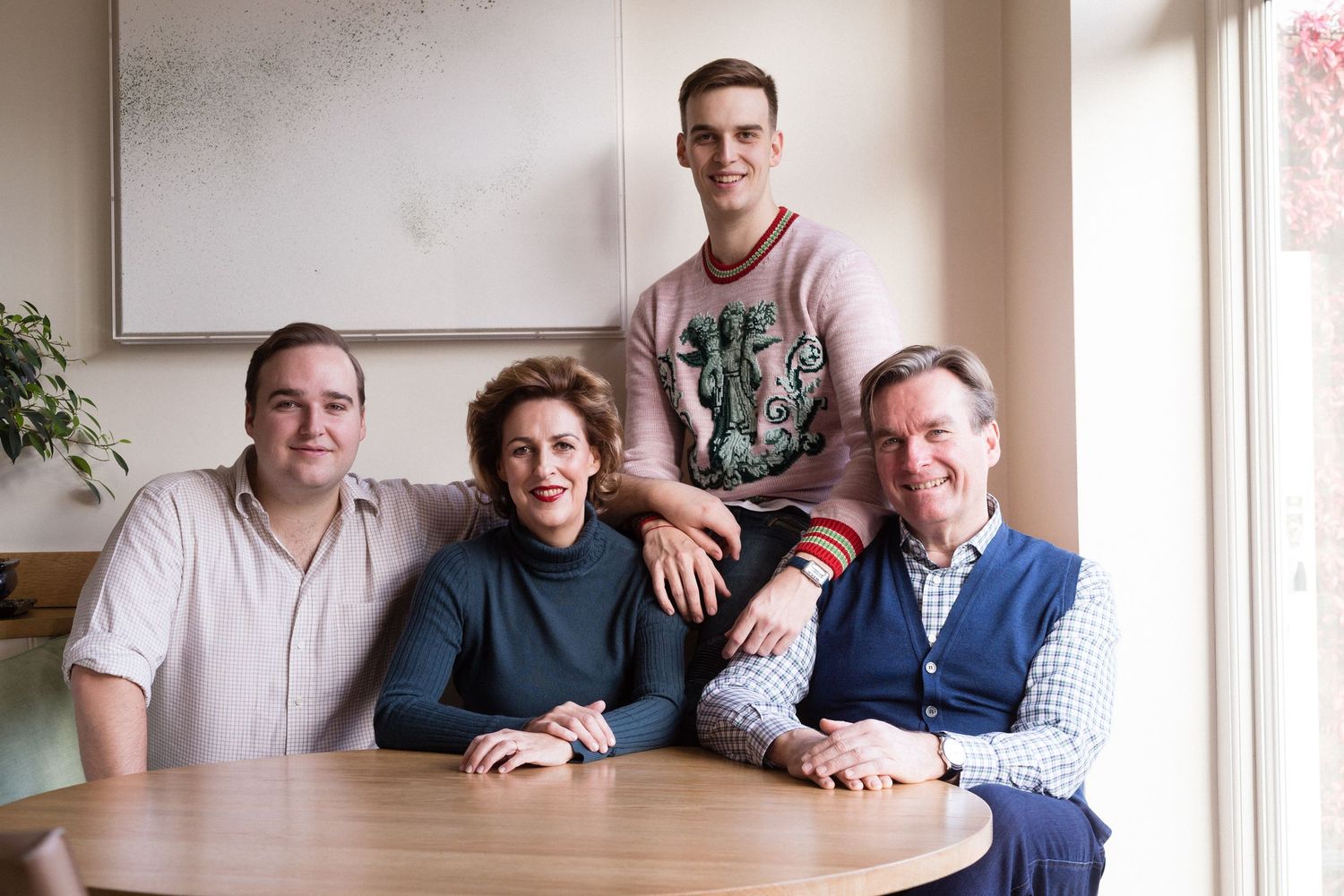 Indoor family portrait session with natural window lighting.