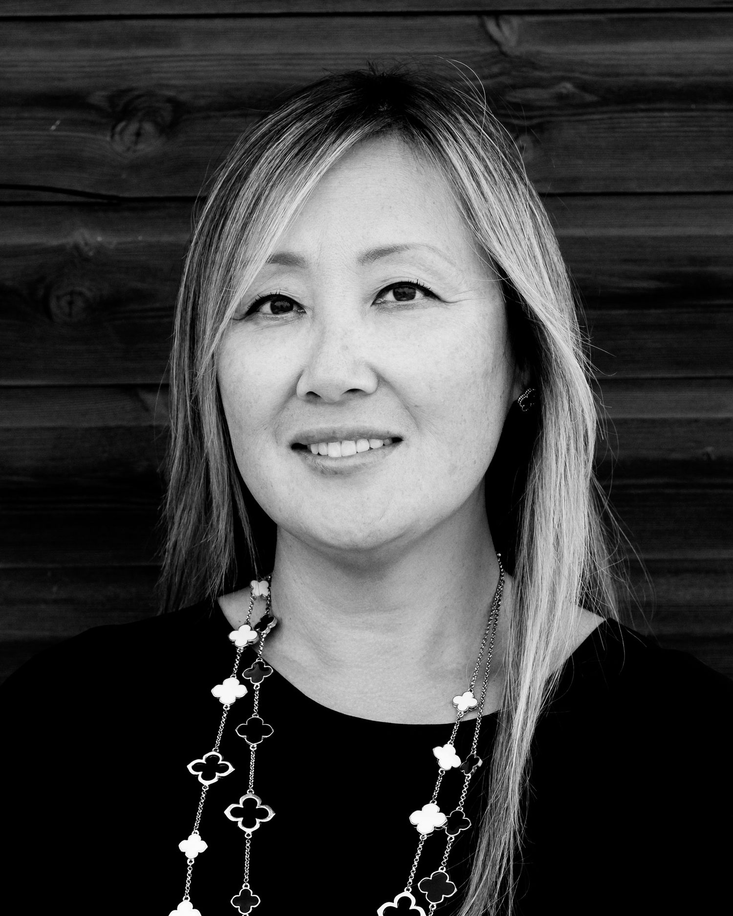 Business headshot Black and white portraits of someone wearing decorative star necklace