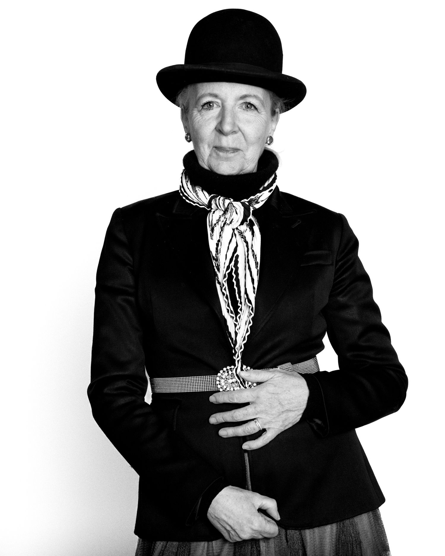 Black and white portrait series of figures in vintage clothing and hats.