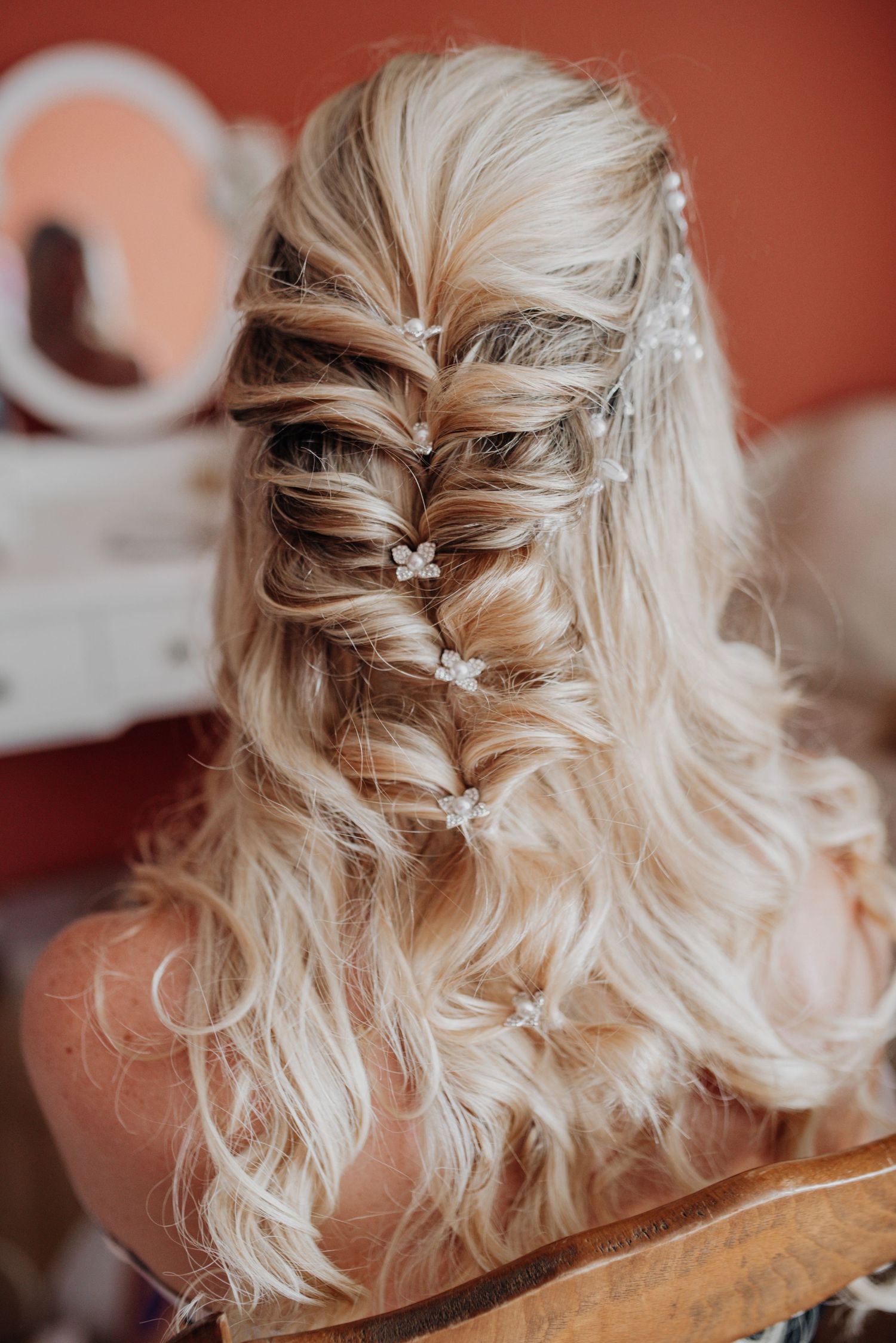 Elegant braided hairstyle with blonde waves cascading down the back.