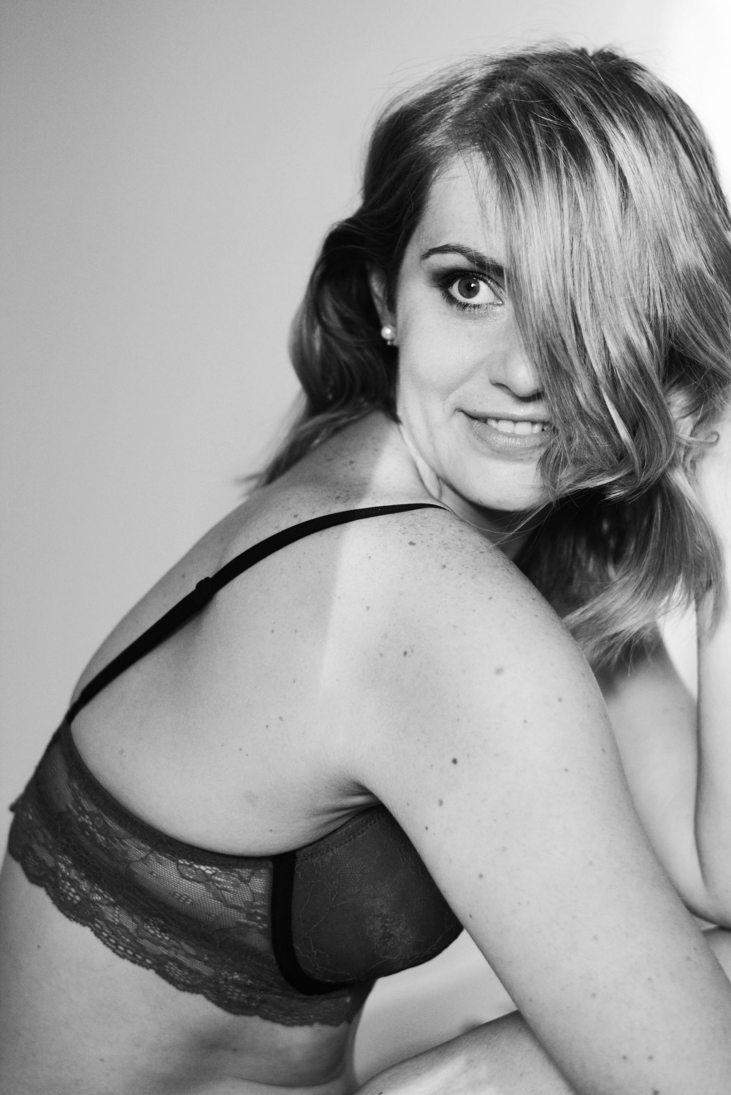 Black and white boudoir series featuring lace details and dramatic poses.