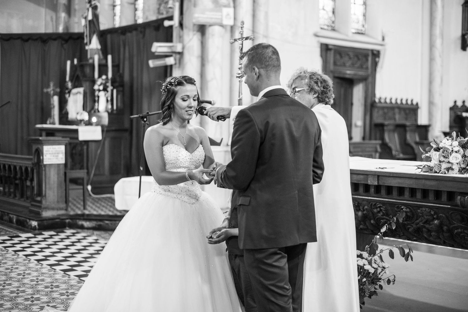 Black and white wedding photos showing intimate moments in an elegant indoor venue.