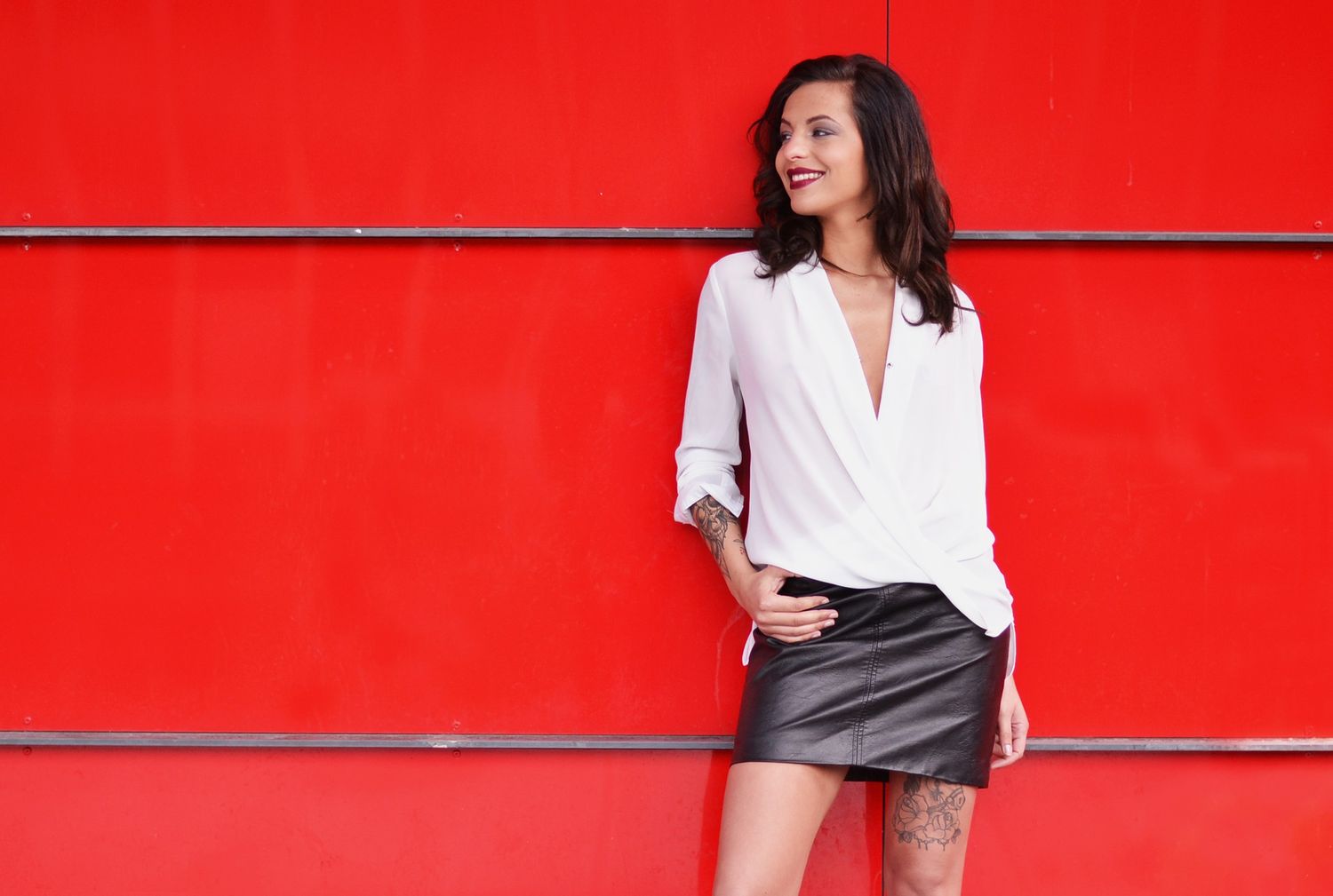 Fashion editorial series against bright red wall showing contemporary street style looks.