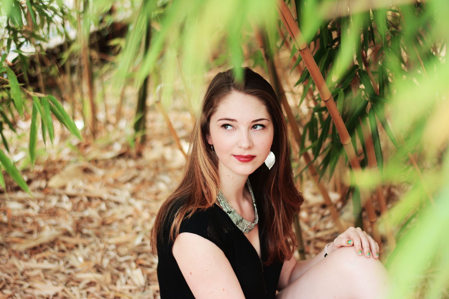 Outdoor portrait series with green foliage and natural lighting.