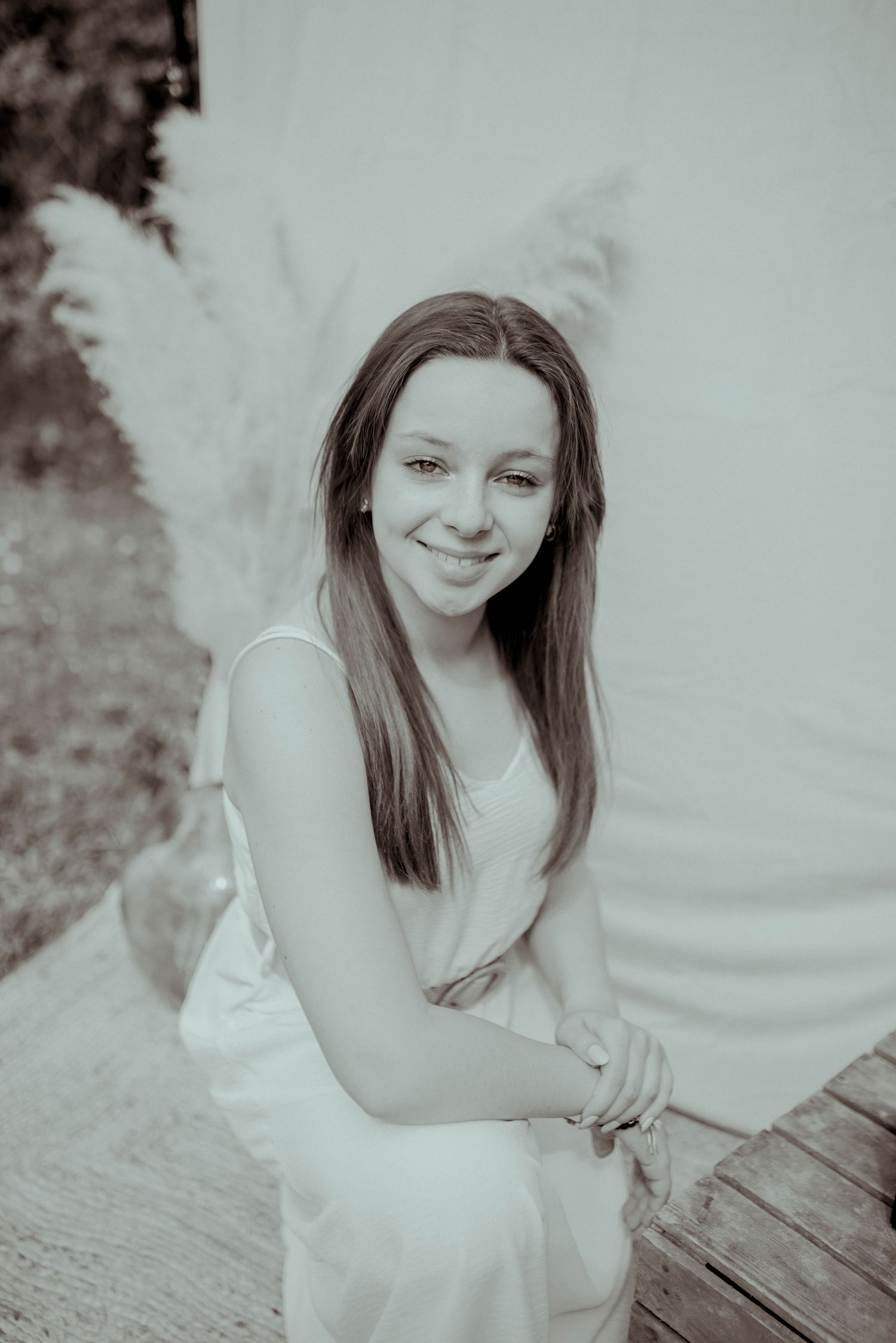A collection of soft black and white portraits showing joyful expressions and white summer dresses.