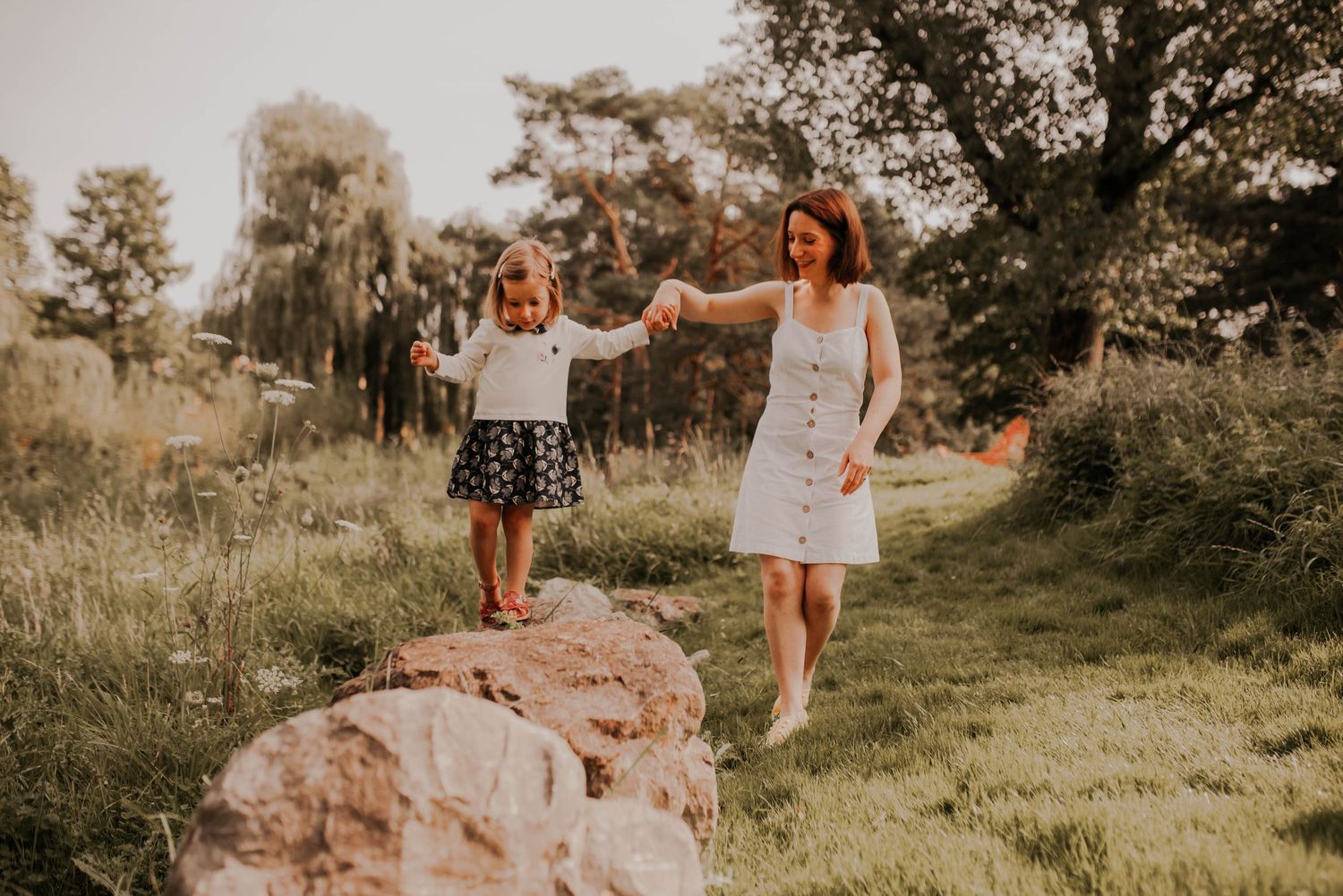 Family members enjoying time together on a rocky outdoor terrain.