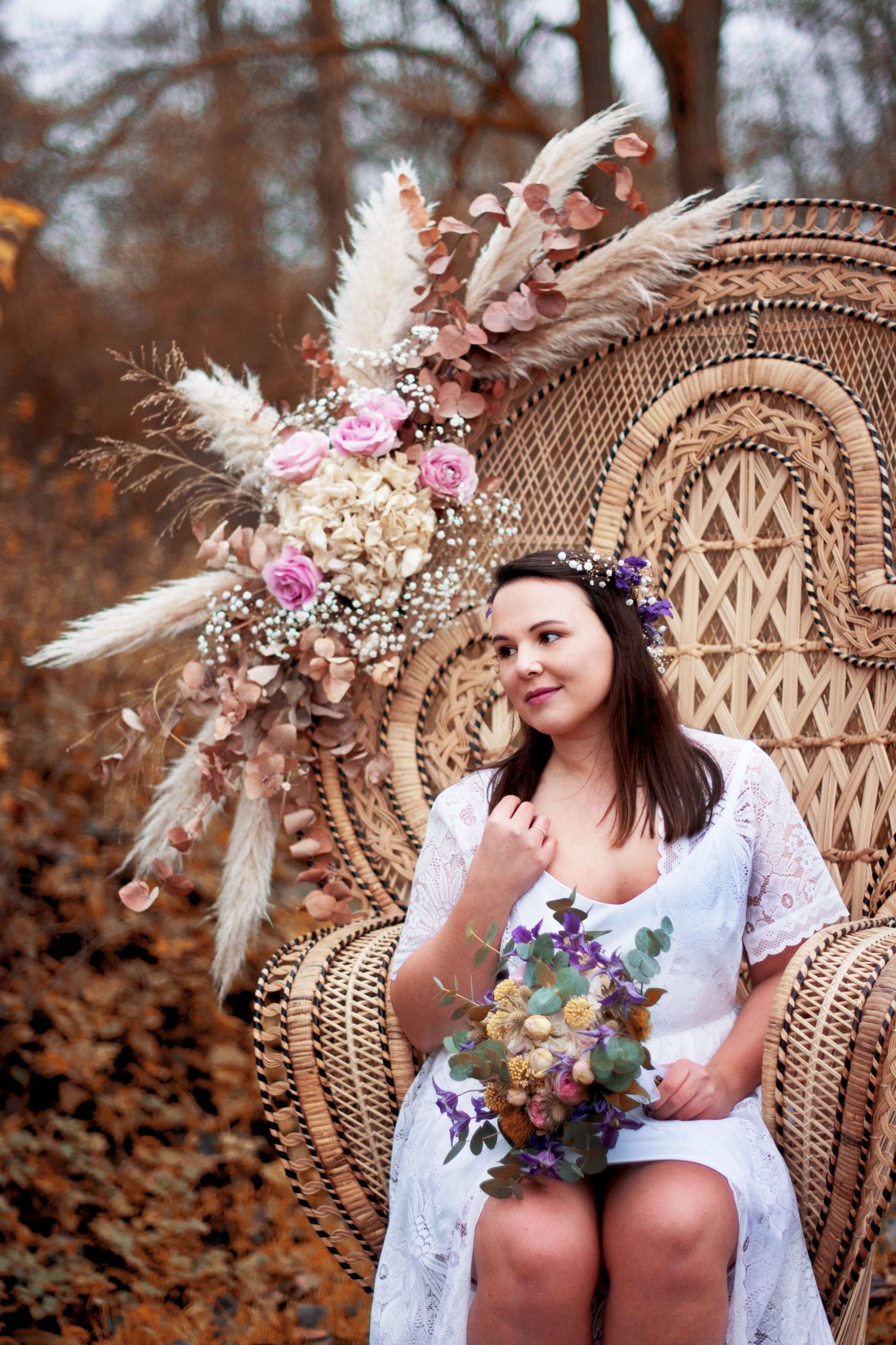 A floral crown and white dress create an ethereal look against an autumn backdrop.