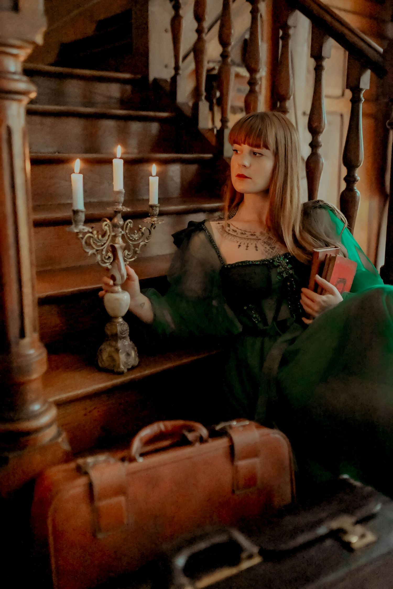 Atmospheric gothic scene with candlelight and dark wooden staircase details.