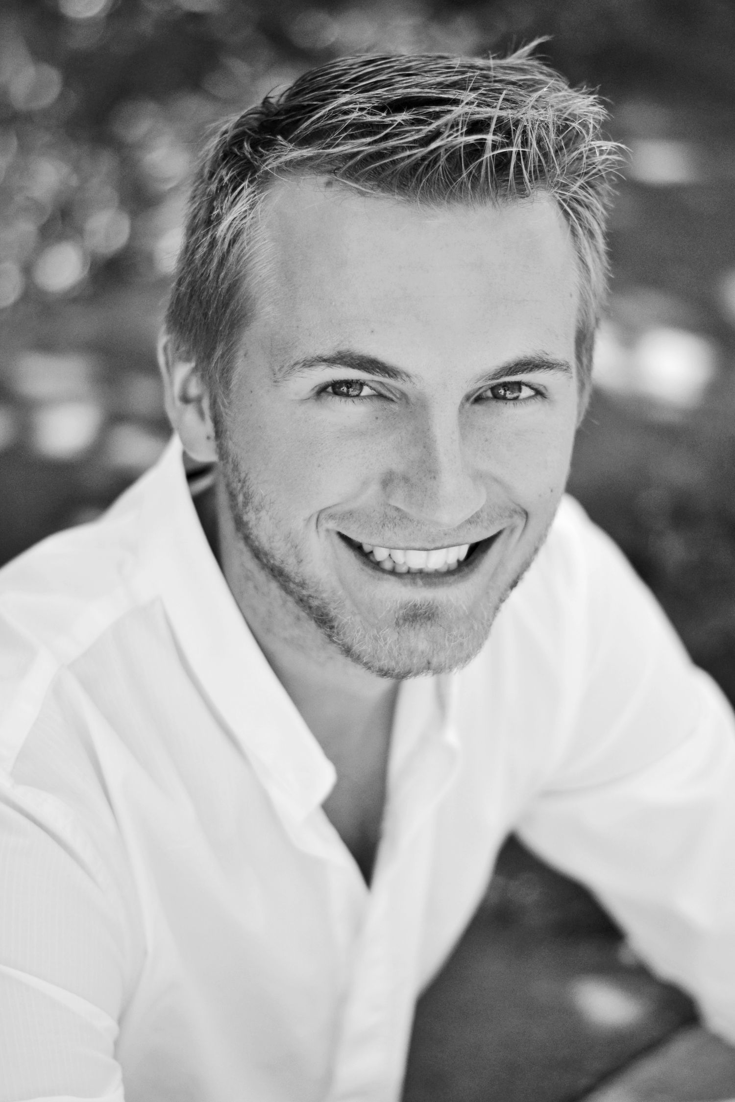 Black and white headshot series showing bright genuine smiles.