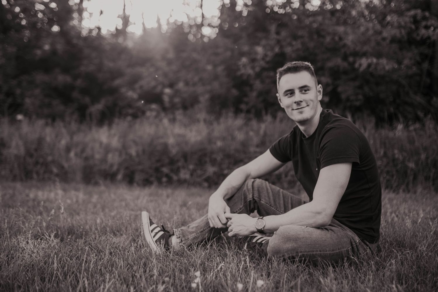 Black and white portrait session in a natural outdoor setting.