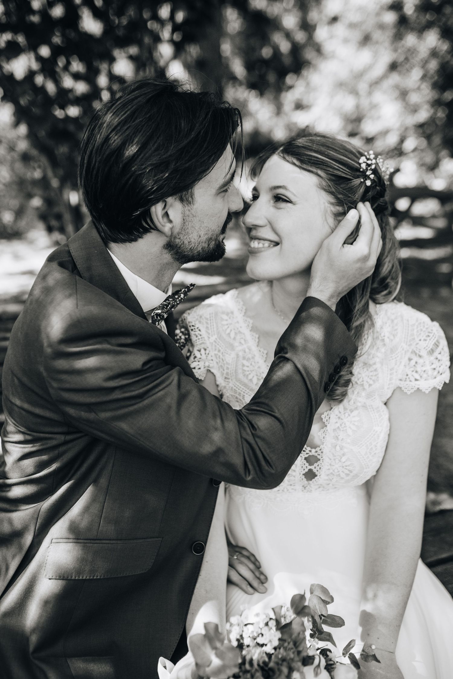 Romantic black and white wedding photos showing tender moments between newlyweds in an outdoor garden setting.