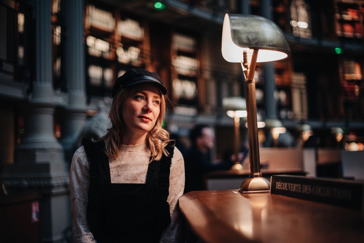 Dark wood library shelves illuminated by soft ambient lighting.