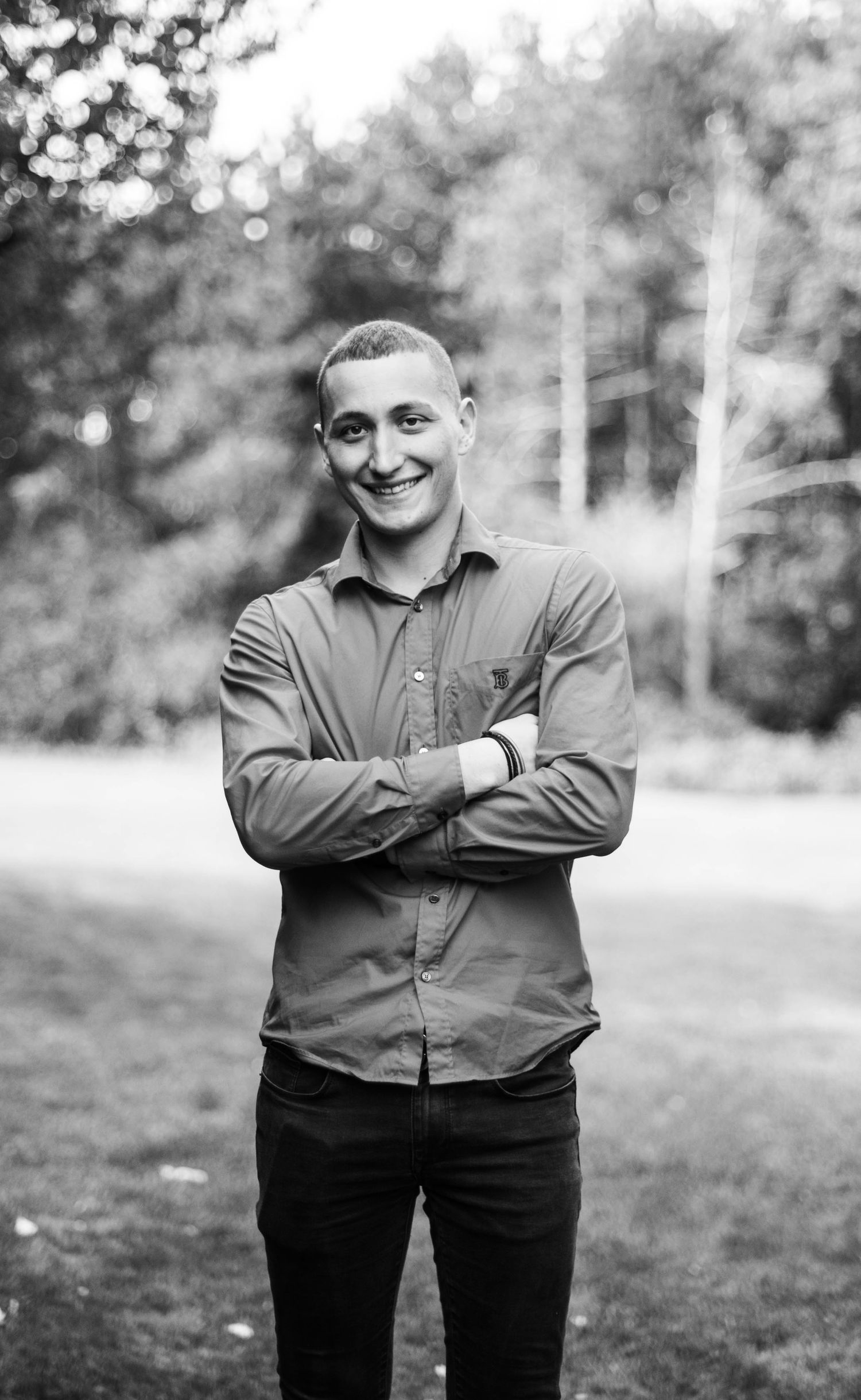 Black and white portrait series showing happy expressions and crossed arms poses.