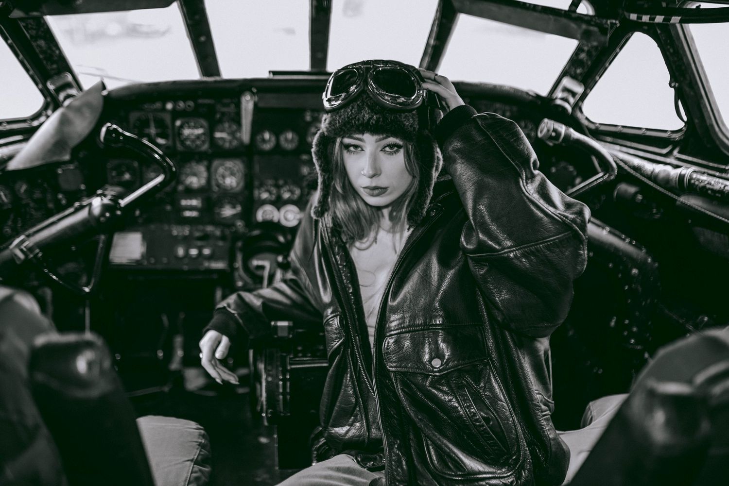 Dramatic black and white cockpit interior shot with aviation controls and instruments.