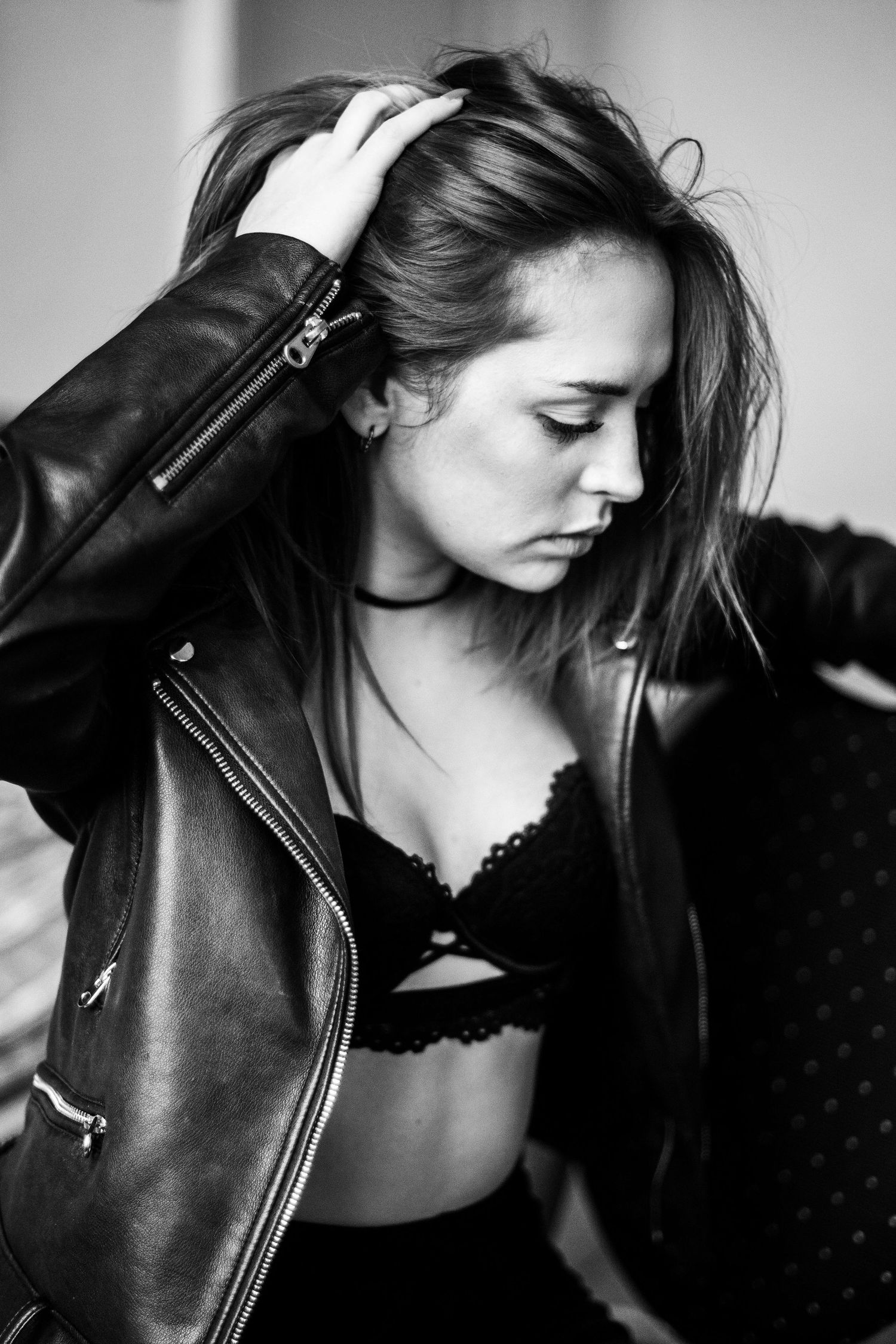 A black and white photo series shows a model in a leather jacket posing dramatically against a dark background.