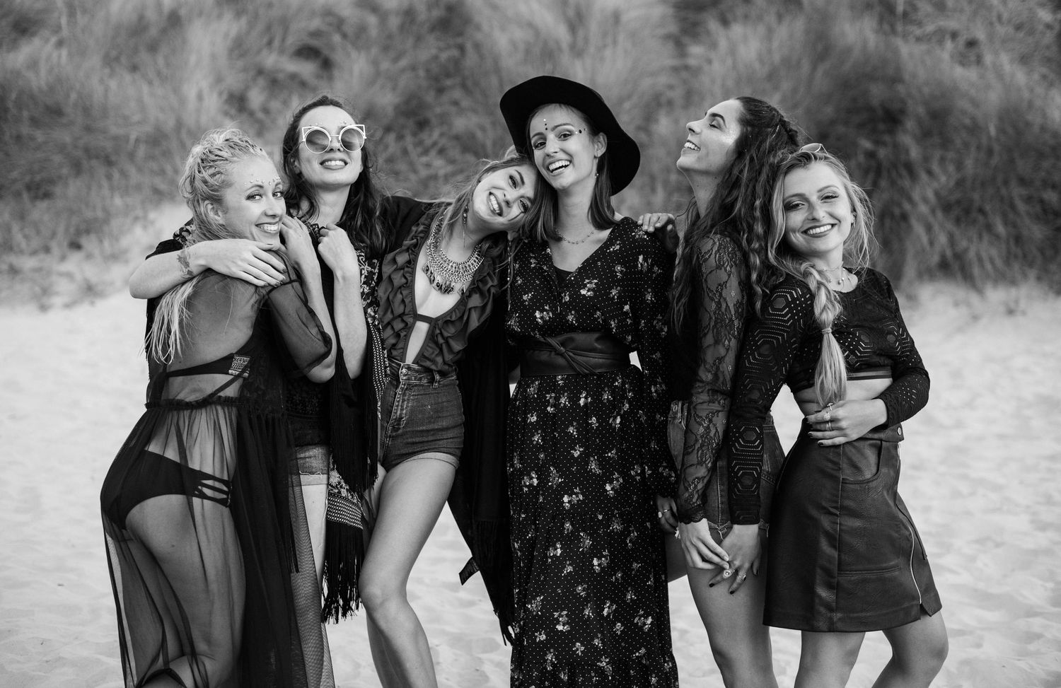 Group of friends laughing and having fun together in black and white photography.