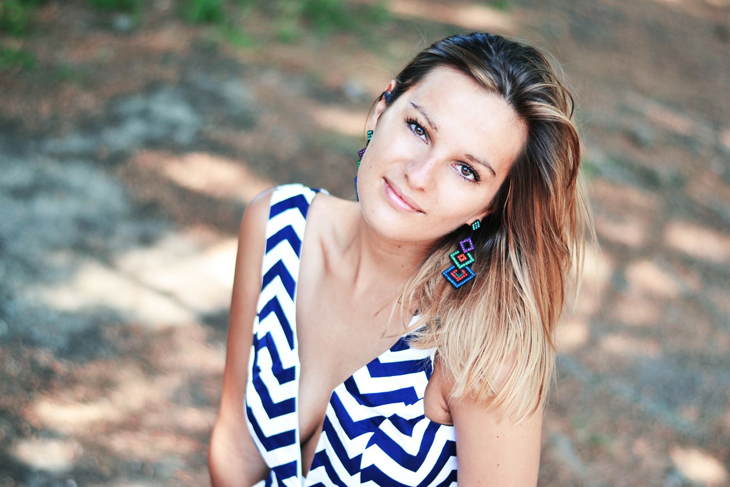 Summer portrait series with nautical striped outfit against natural backgrounds.
