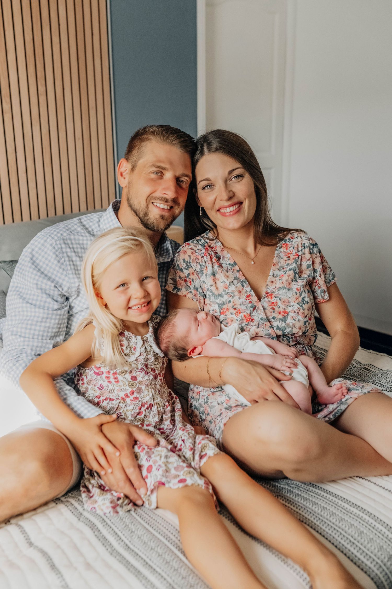 Family sharing joyful moments together on a gray couch.