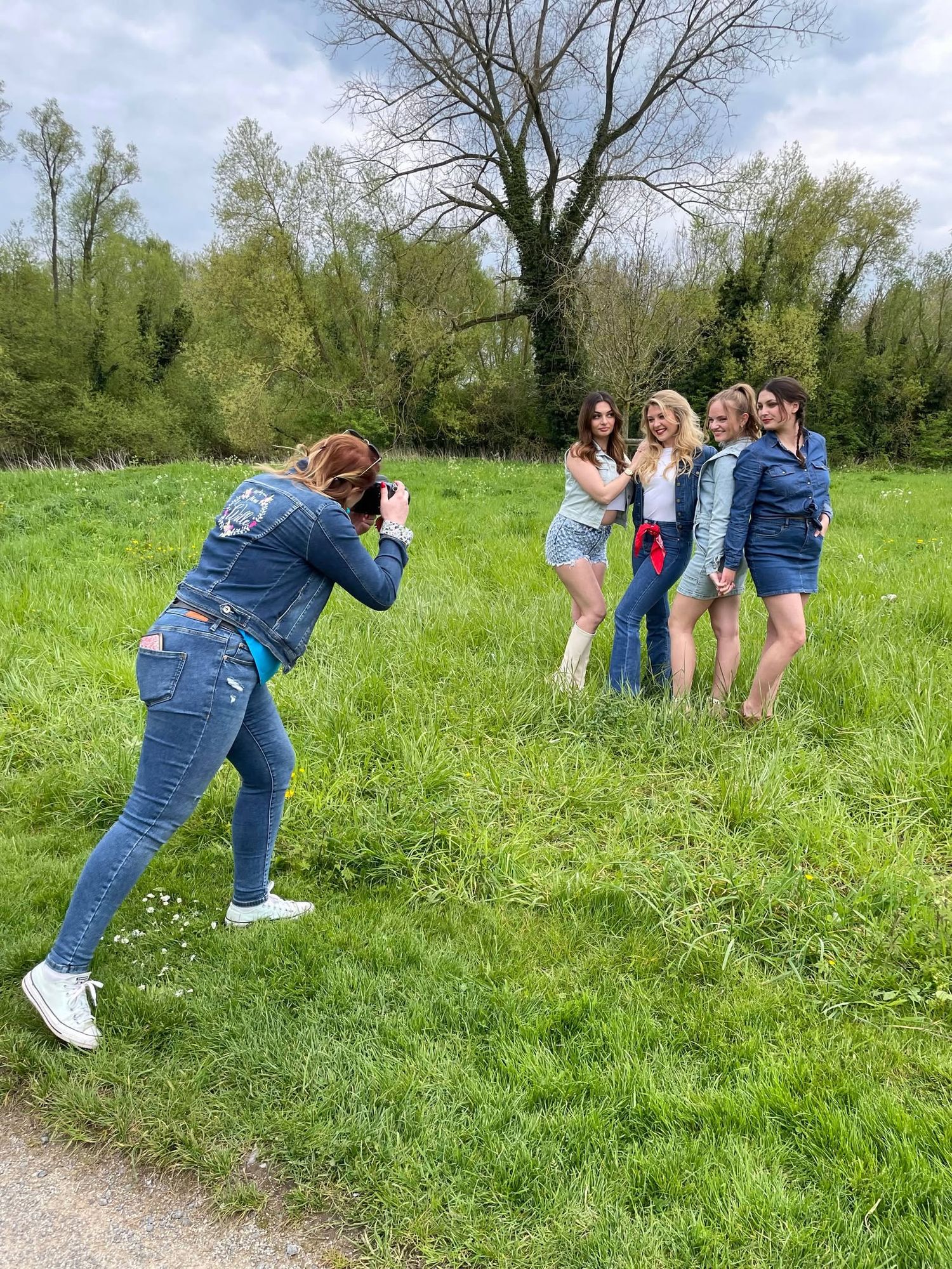 Photographers taking creative angles while shooting photos in a spring meadow.