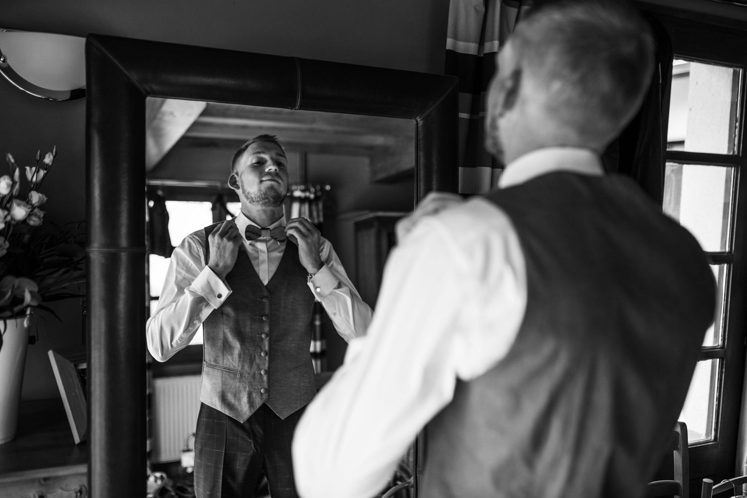 Black and white photos of wedding preparation moments in a sunlit room.
