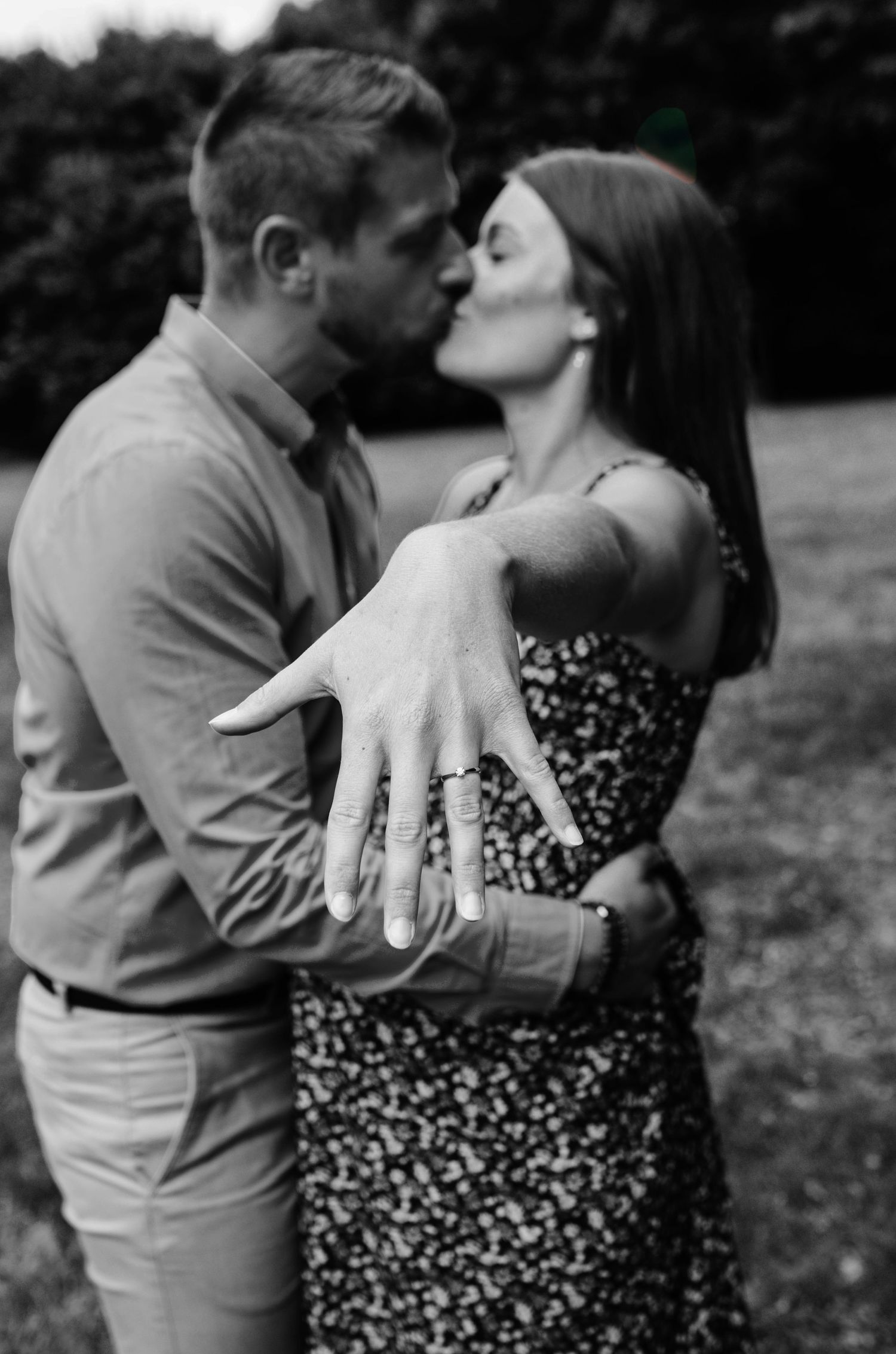 Black and white photo series of a couple embracing outdoors in casual attire.