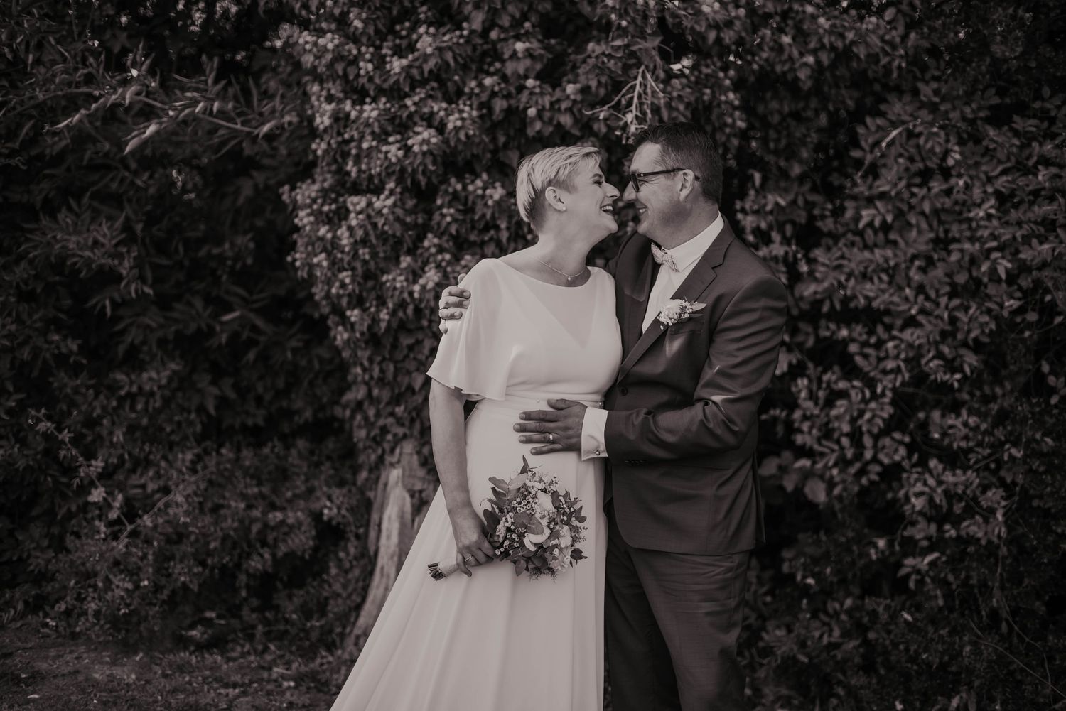 Black and white wedding portraits captured in a natural outdoor setting.