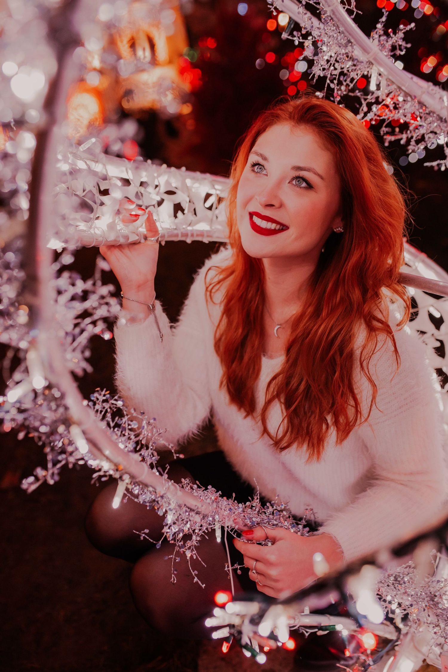 Festive portrait with bokeh lights and sparkles creating a magical mood.