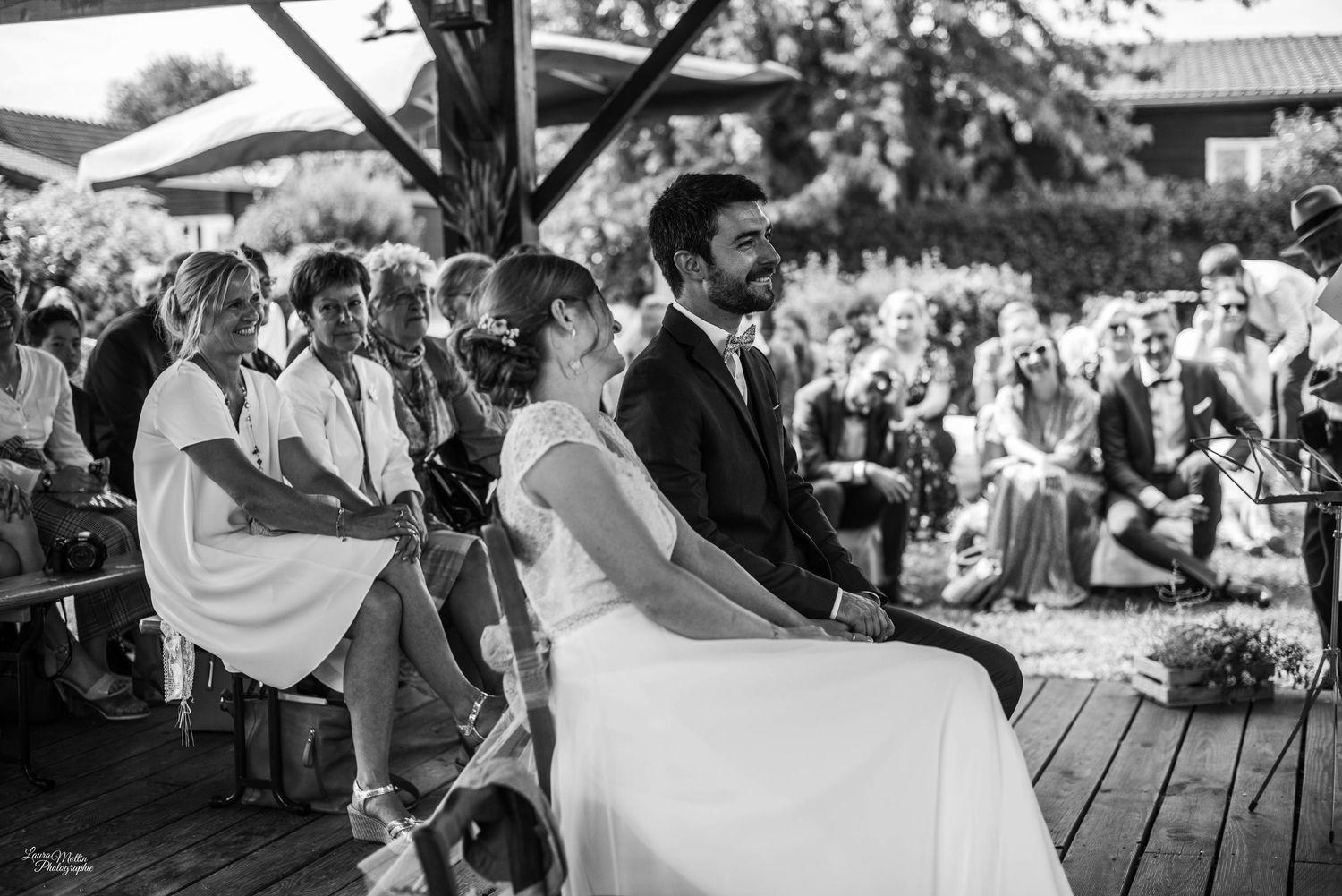 Wedding guests enjoying an outdoor reception celebration under a tent.