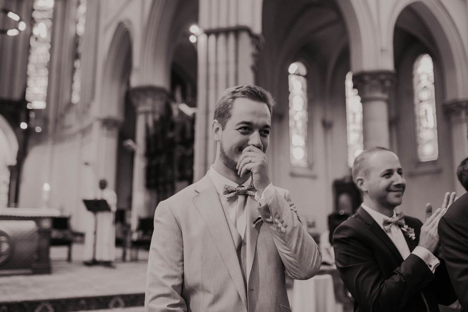 Wedding ceremony in a historic church with gothic arches and elegant architecture.