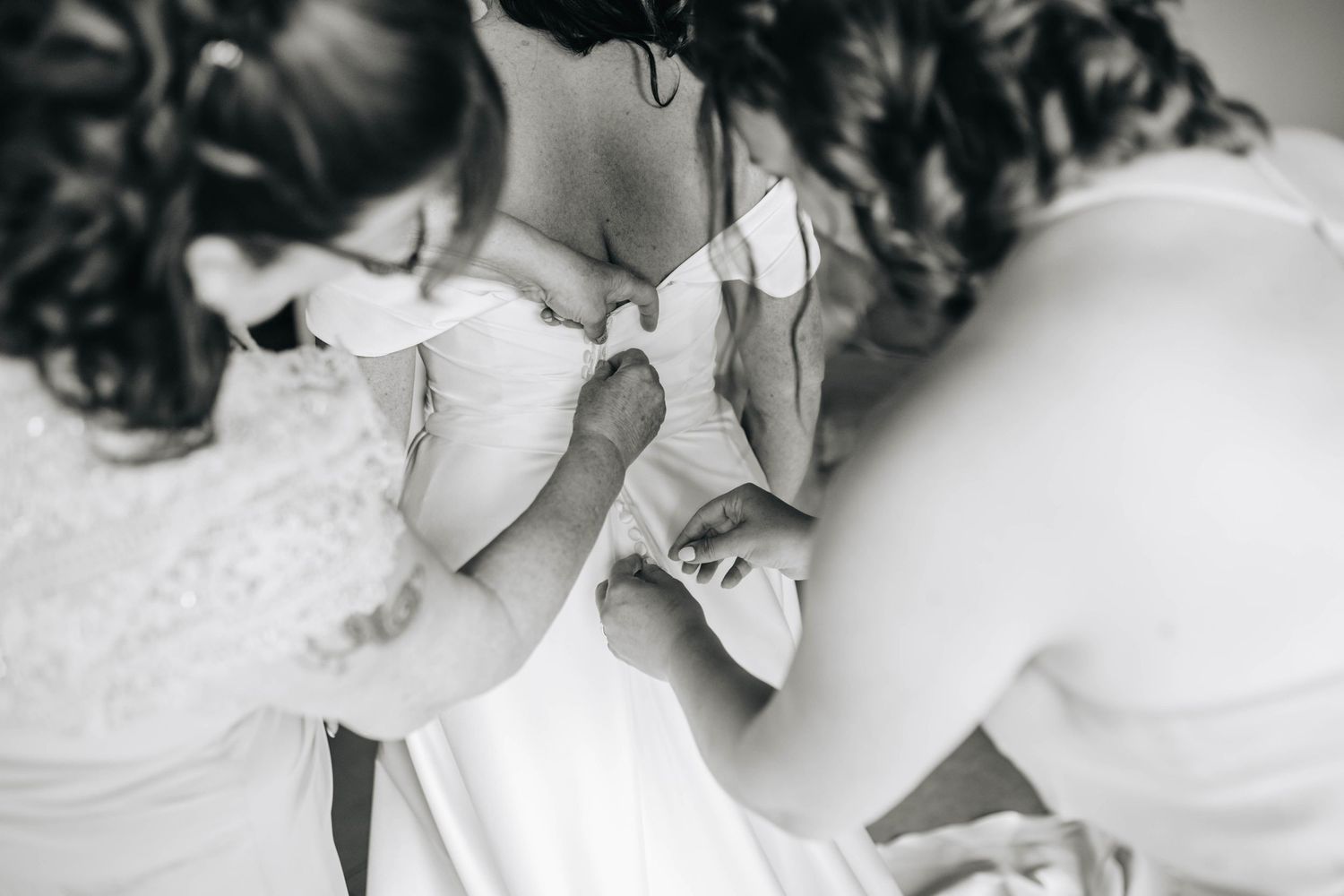 Artistic black and white close-up of wedding day details and accessories.