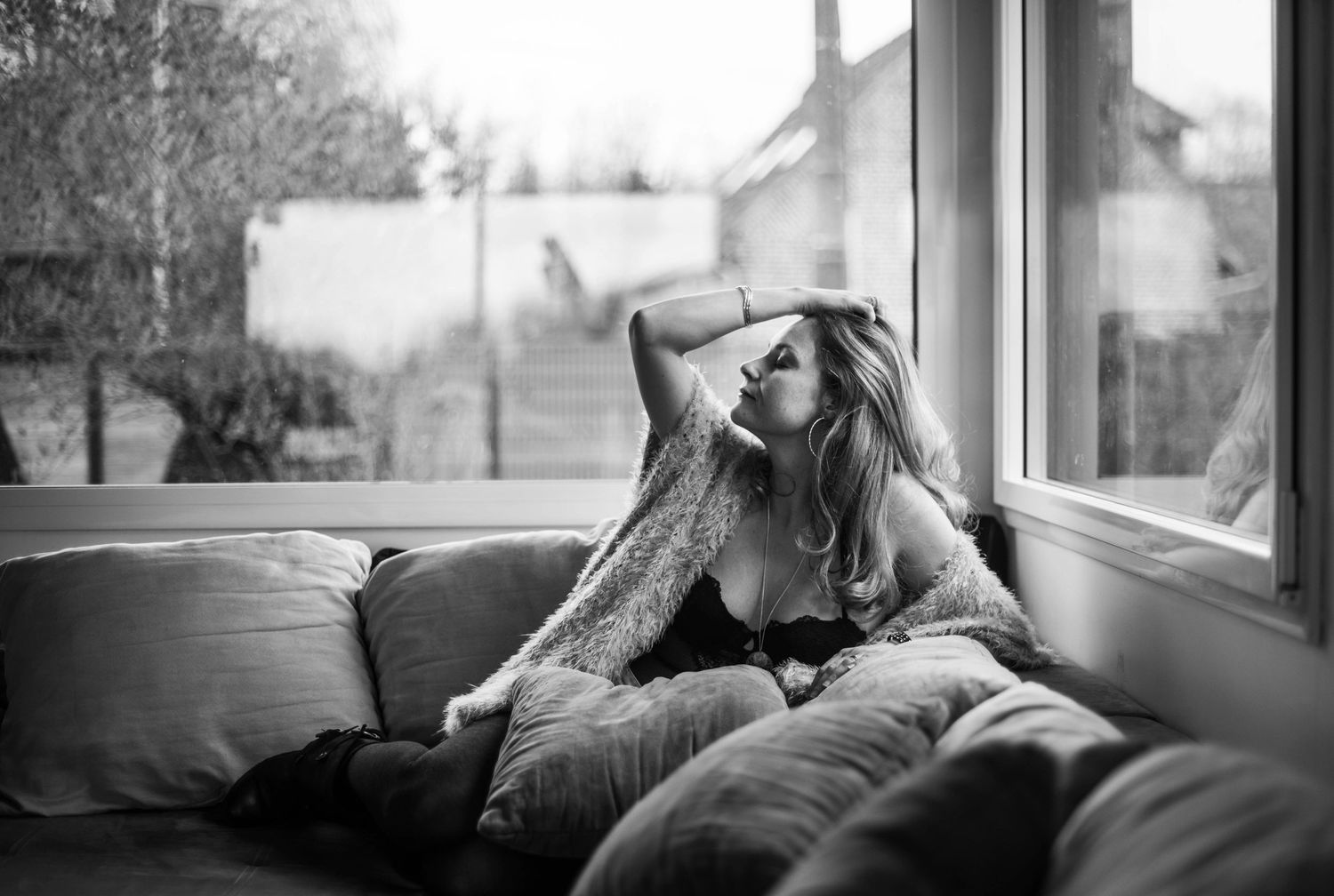 Intimate lifestyle photos by window with natural light and casual poses.