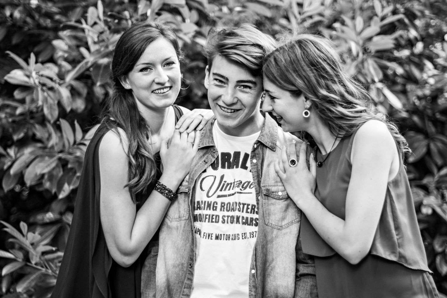 Candid black and white photo series showing friends laughing together outdoors.