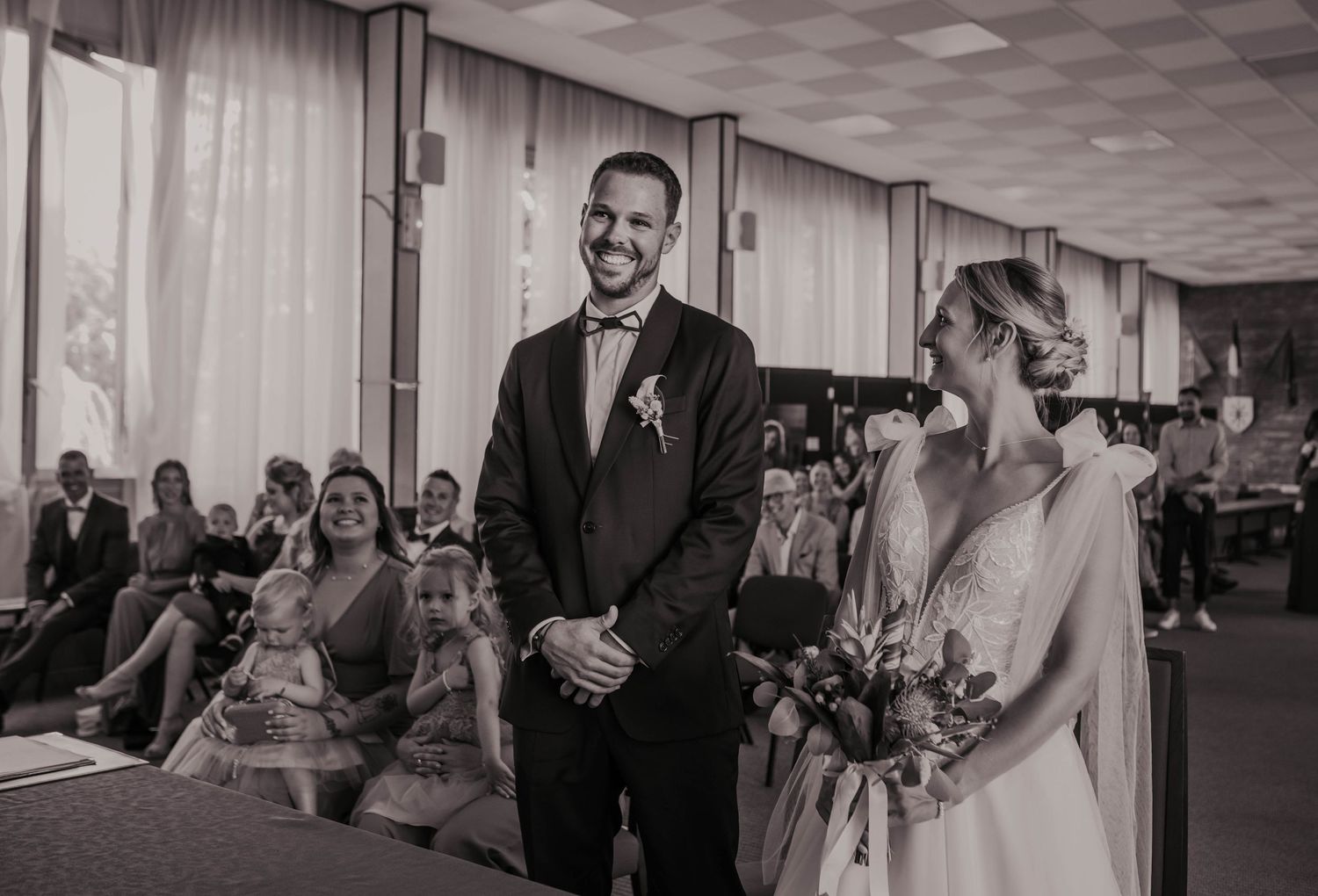 Indoor wedding reception with elegant decor and guests celebrating in a spacious venue.