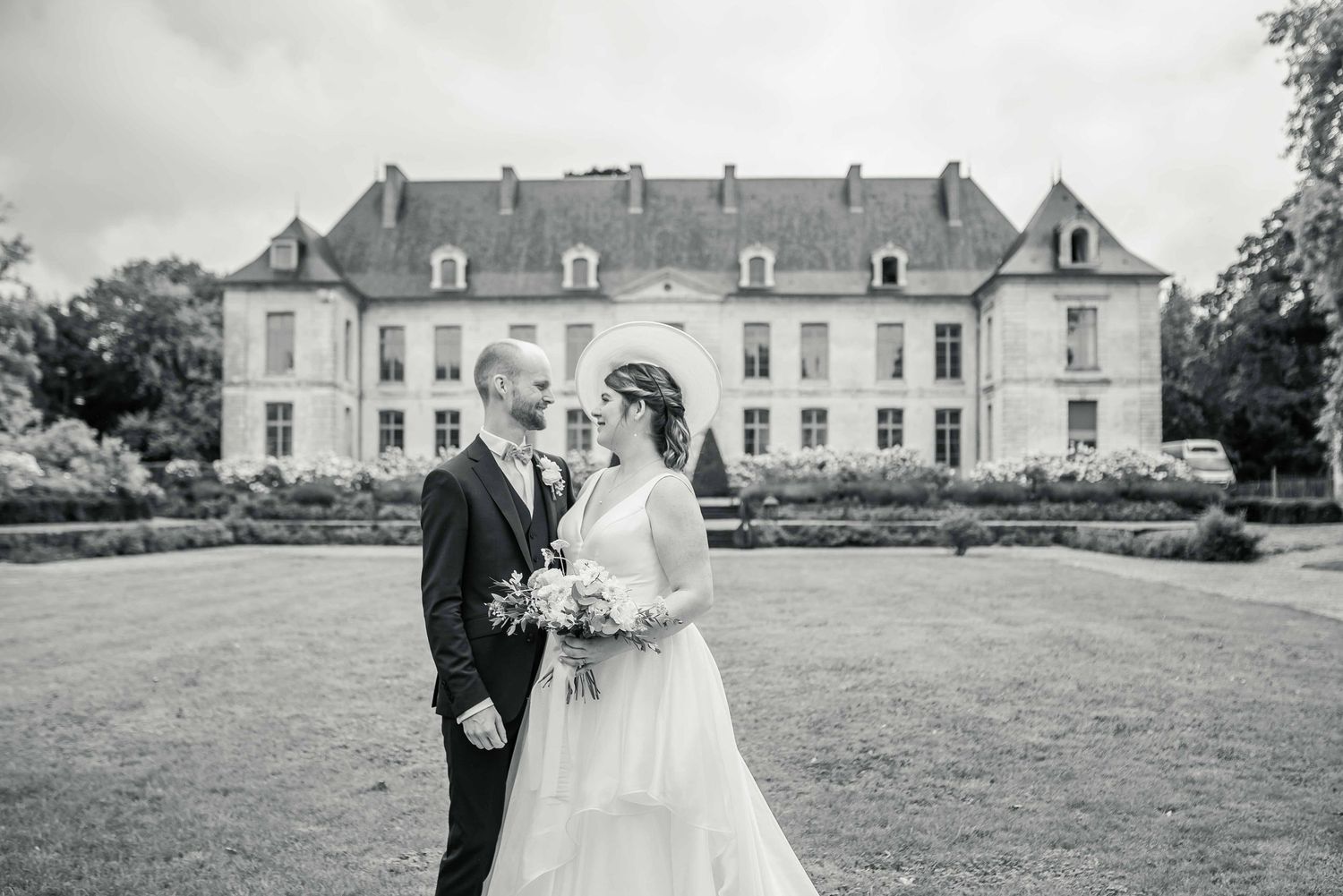 A classic black and white wedding portrait in front of a majestic French chateau.