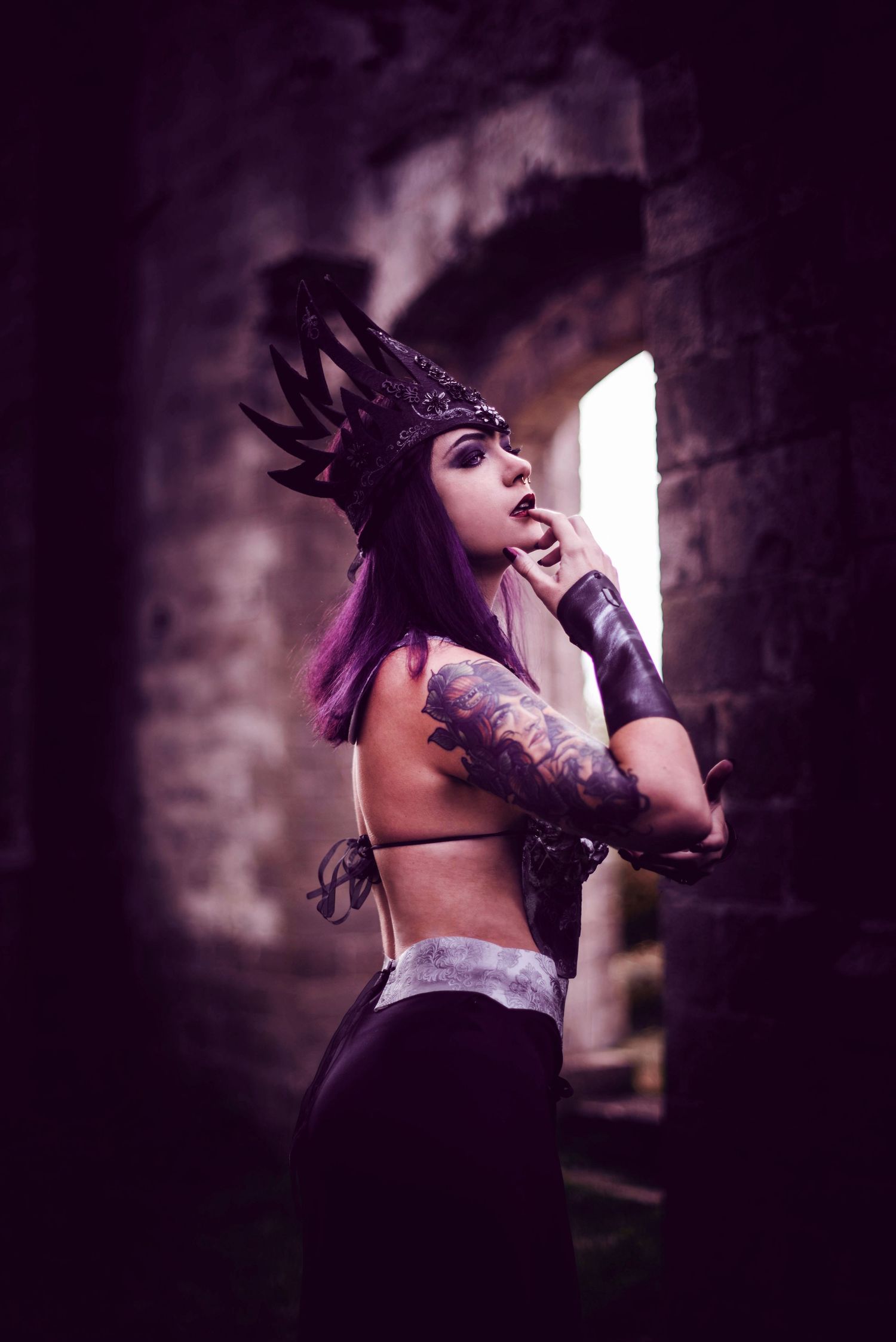 Dark gothic fashion shoot featuring dramatic poses in stone architecture.