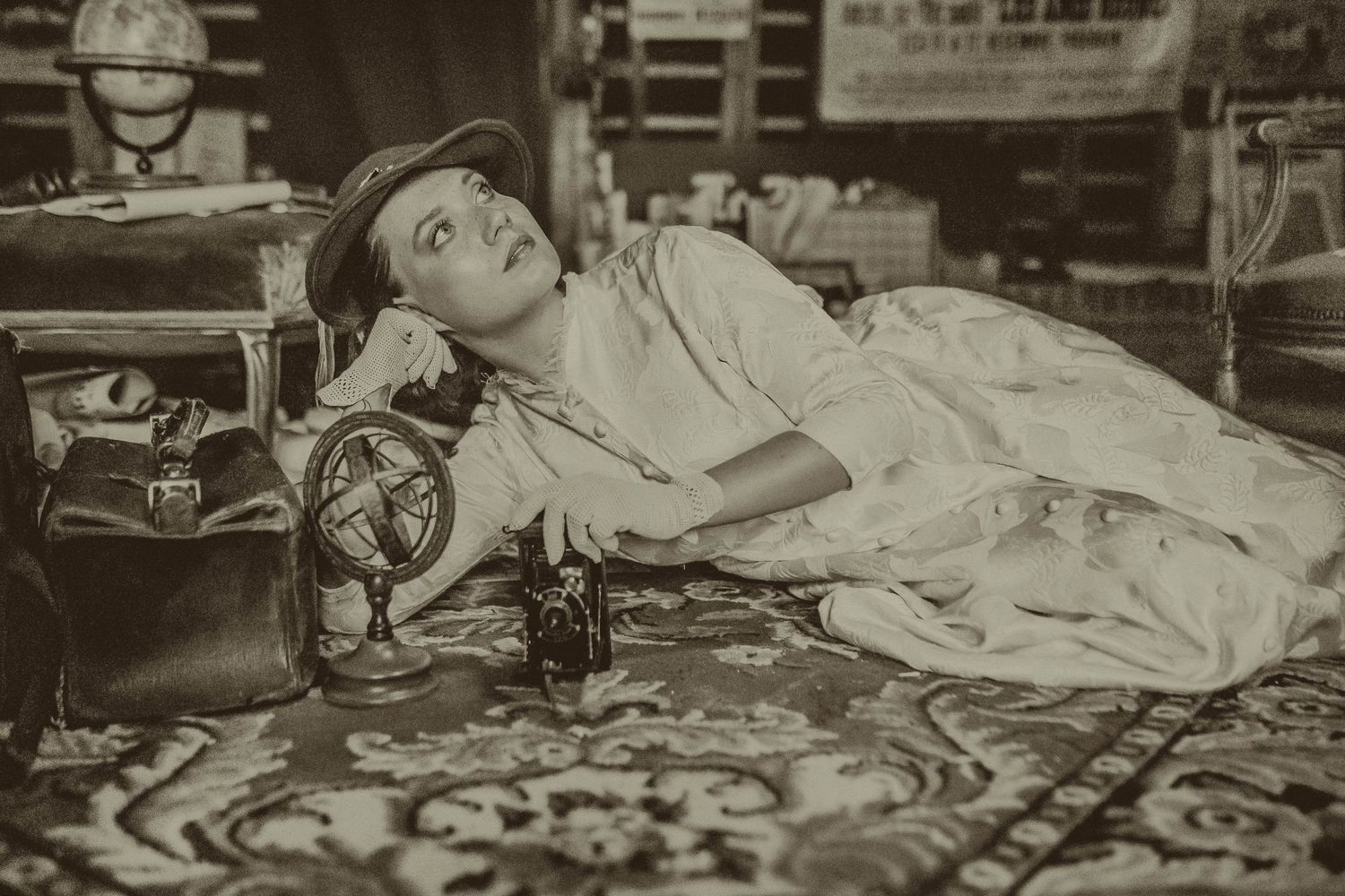 Vintage sepia photograph showing antique sewing machine and fabric.