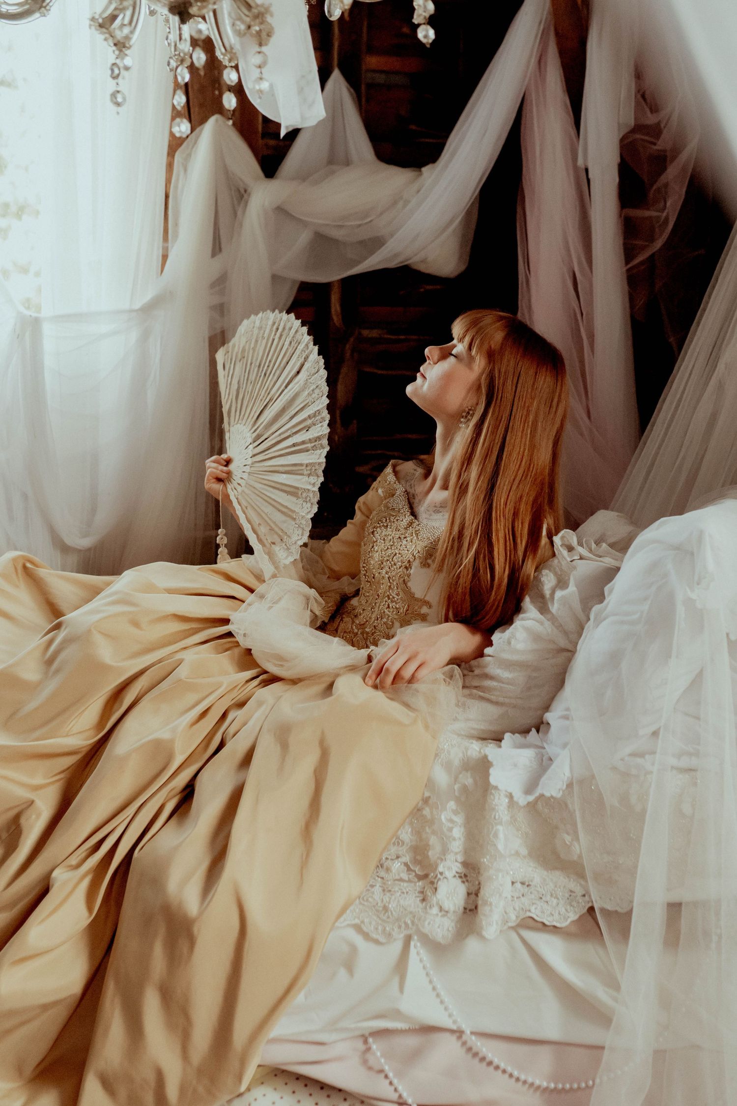 Romantic vintage-style scene with decorative fan and draped fabrics.