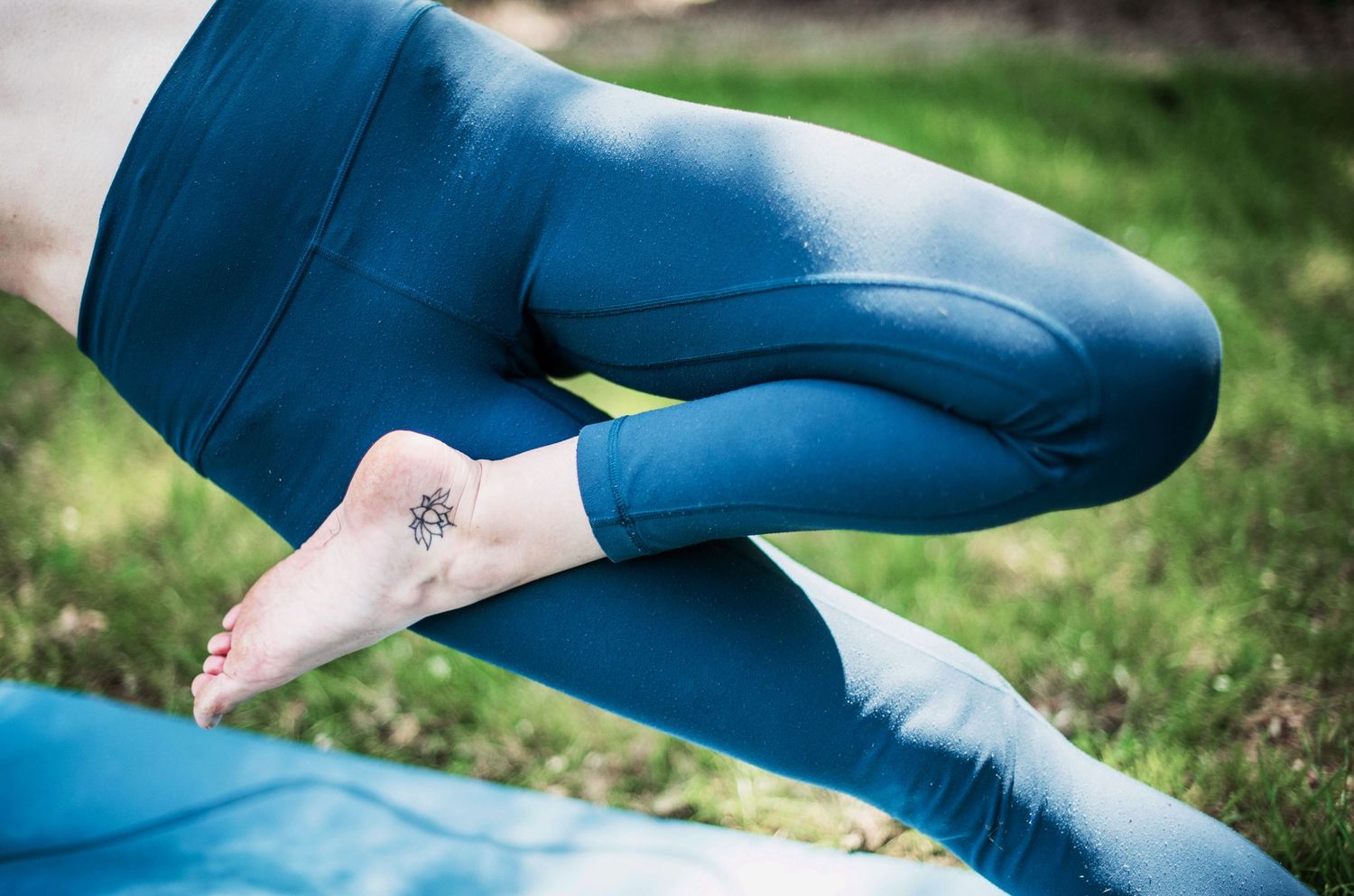 Close-up of yoga poses showing blue athletic wear details.