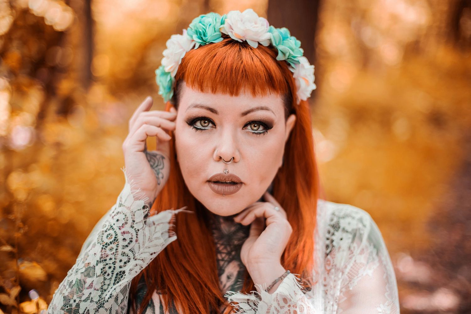 Portrait with mint flower crown and lace top against warm autumn background.