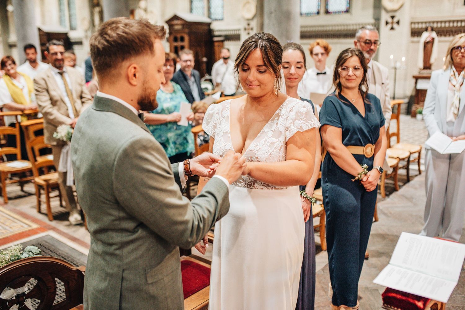 Wedding celebration inside historic church with guests and decorative details.