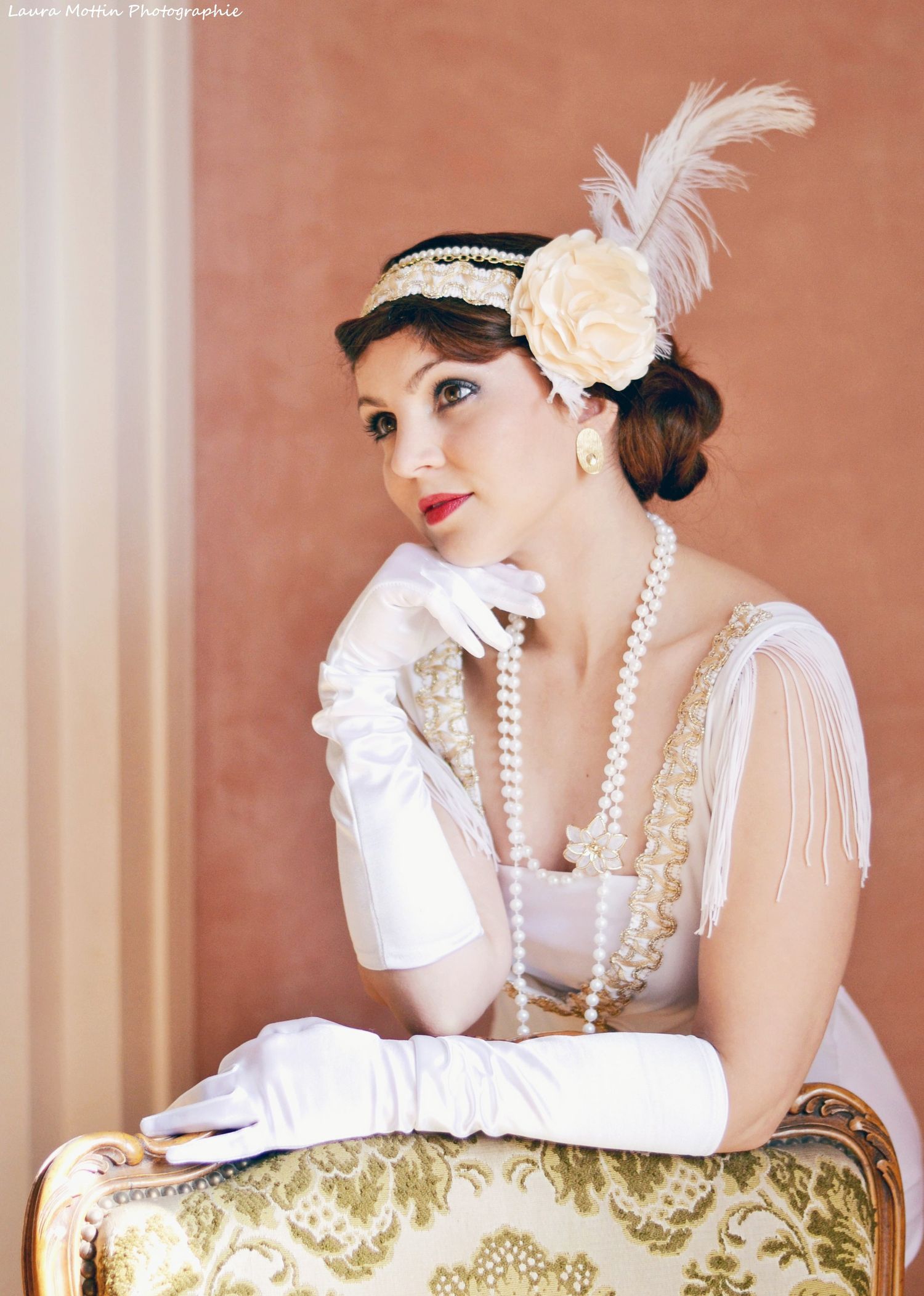 1920s inspired portrait with feather headpiece, pearls and long white gloves.