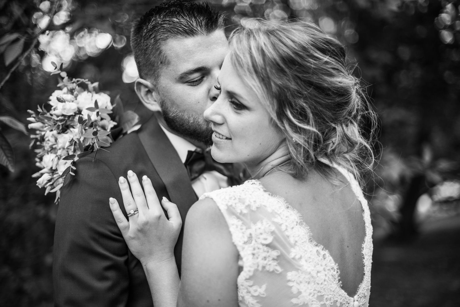 Intimate black and white portraits of a couple sharing tender moments on their wedding day.