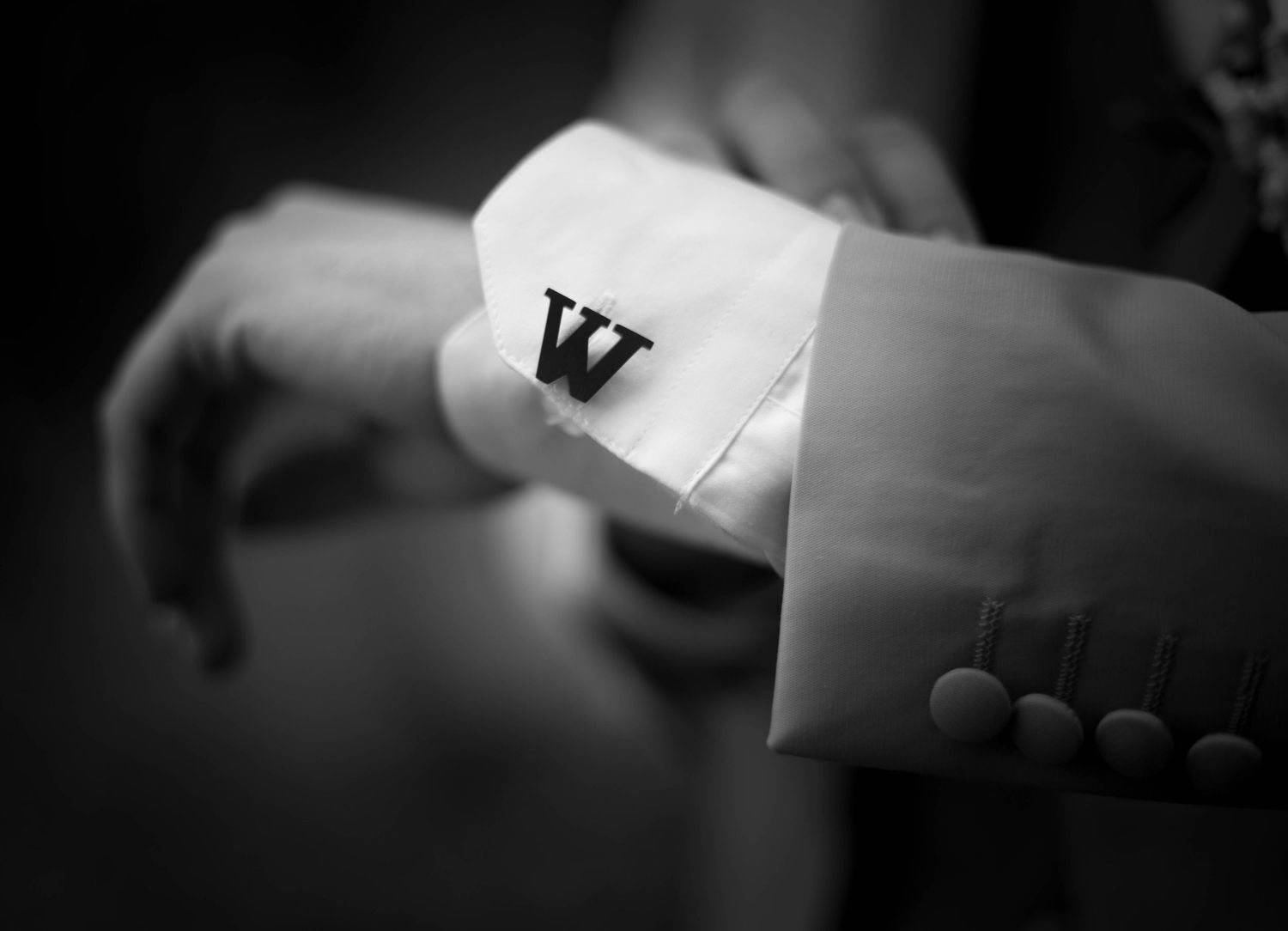 Artistic black and white detail shot of wedding day preparations.