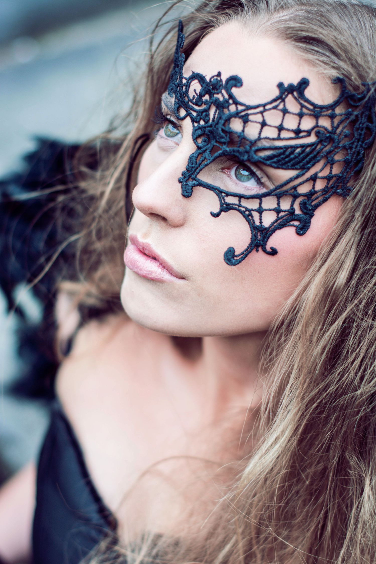 Close-up shots showcasing ornate black lace masquerade mask against soft lighting.