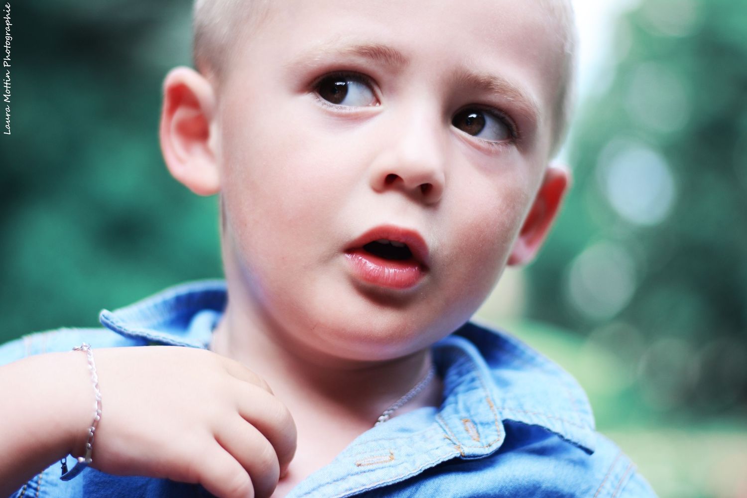 Close-up portraits of children with playful expressions in outdoor setting.