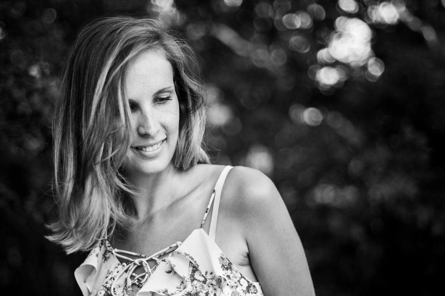 Black and white portrait with dreamy bokeh background.